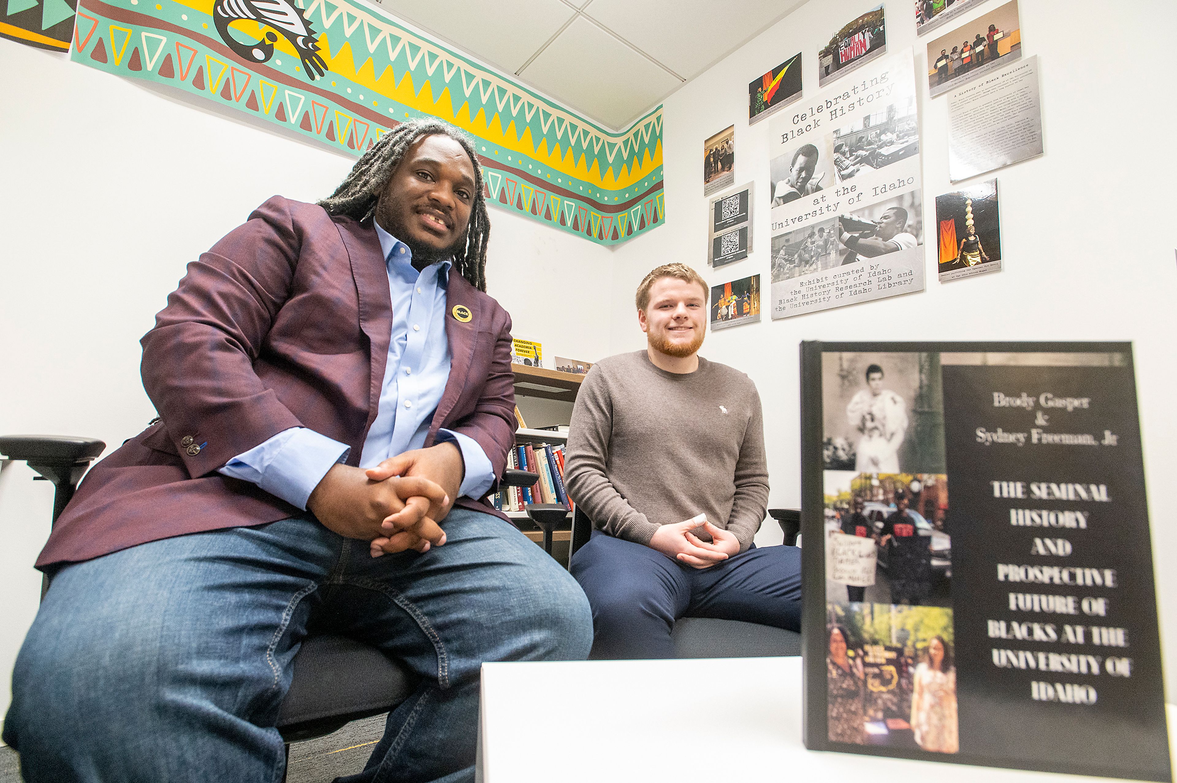 Director Sydney Freeman, Jr., and project manager Brody Gasper pose Monday with a copy of their new book, “The Seminal History and Prospective Future of Blacks at the University of Idaho,” in the Black History Research Lab on campus in Moscow.