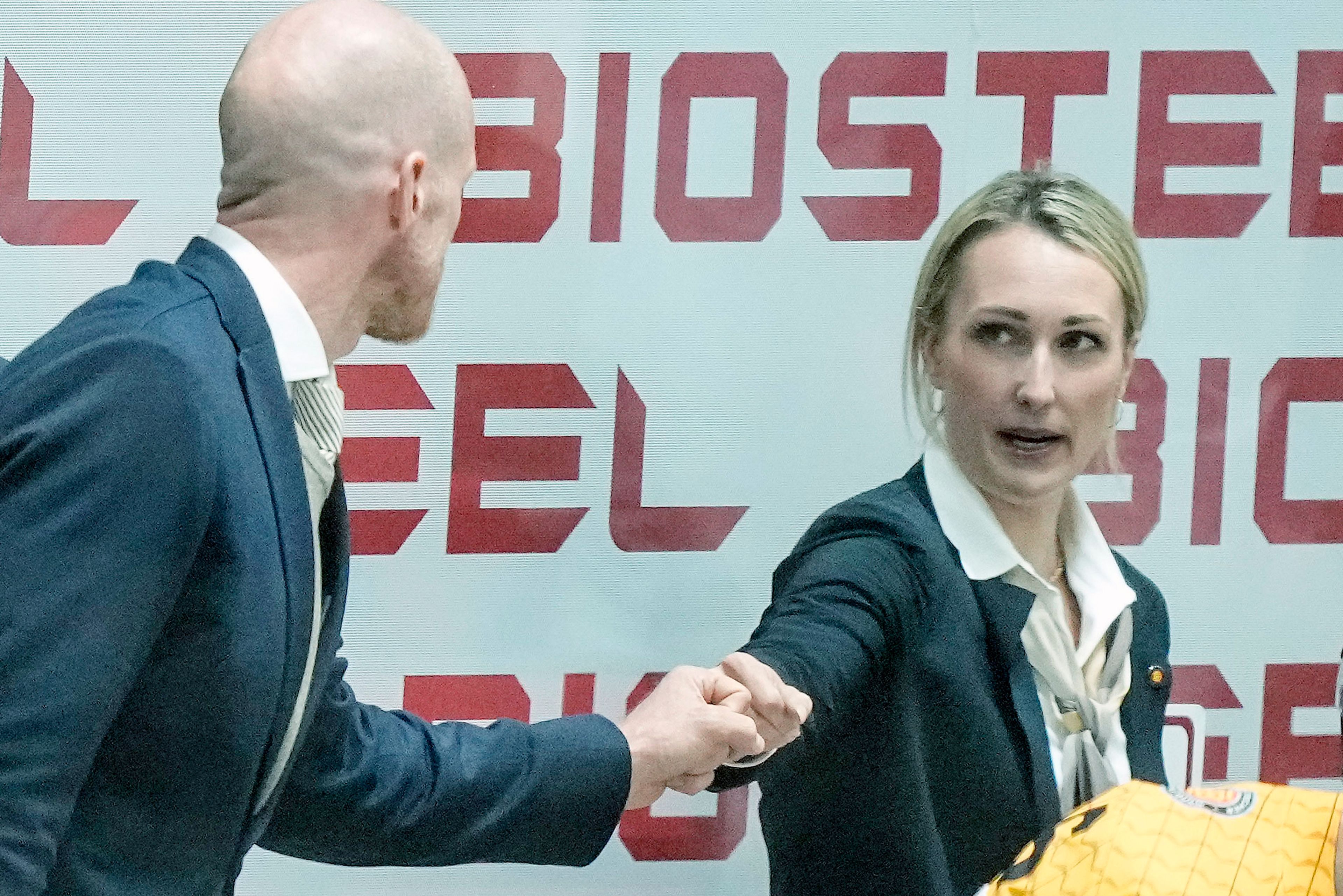 FILE - Germany's assistant coach Jessica Campbell fist bumps with head coach Toni Soderholm after winning the group A Hockey World Championship match between Germany and Italy in Helsinki, Finland, Friday May 20 2022. Jessica Campbell will become the first woman to work on the bench of an NHL franchise after the Seattle Kraken hired her as an assistant coach Wednesday, July 3, 2024.(AP Photo/Martin Meissner, File)