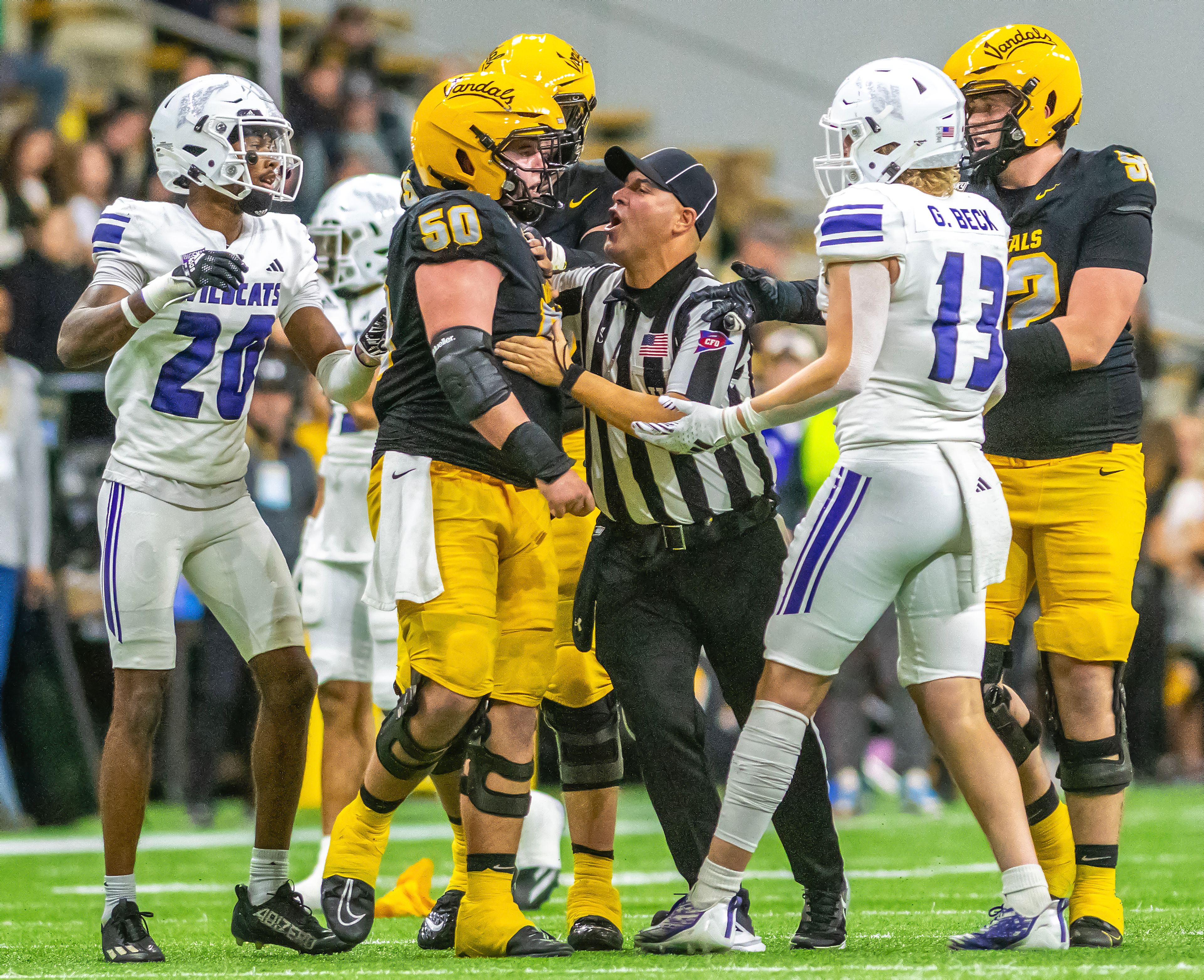 Officials break up Idaho offensive lineman Layton Vining and Weber State linebacker Garrett Beck during a quarter of a Big Sky conference game Saturday at the P1FCU Kibbie Dome in Moscow.