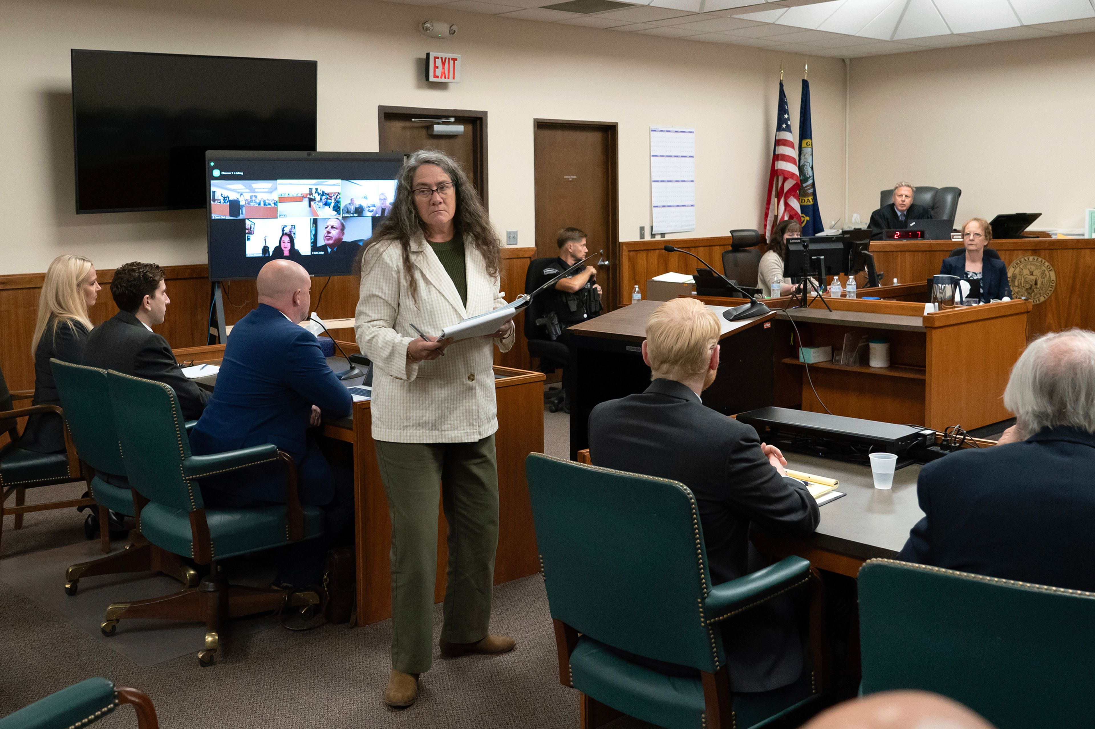 Wendy Olson, center, an attorney representing a coalition of news organizations including The Associated Press, steps away after speaking during a hearing in Latah County District Court, Wednesday, Sept. 13, 2023, in Moscow, Idaho, after asking Second District Judge John C. Judge to continue to allow cameras in the courtroom in the trial of Bryan Kohberger, second from left, who is accused of killing four University of Idaho students in November 2022. (AP Photo/Ted S. Warren, Pool)