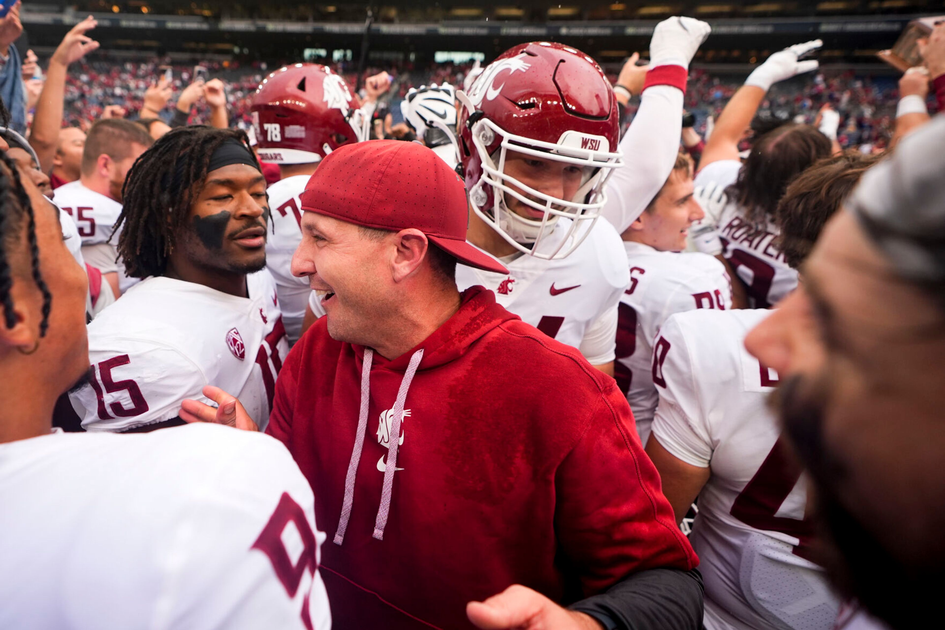 Washington State head coach Jake Dickert greets his players as they celebrate a 24-19 win over Washington in an NCAA college football game Saturday, Sept. 14, 2024, in Seattle. (AP Photo/Lindsey Wasson)