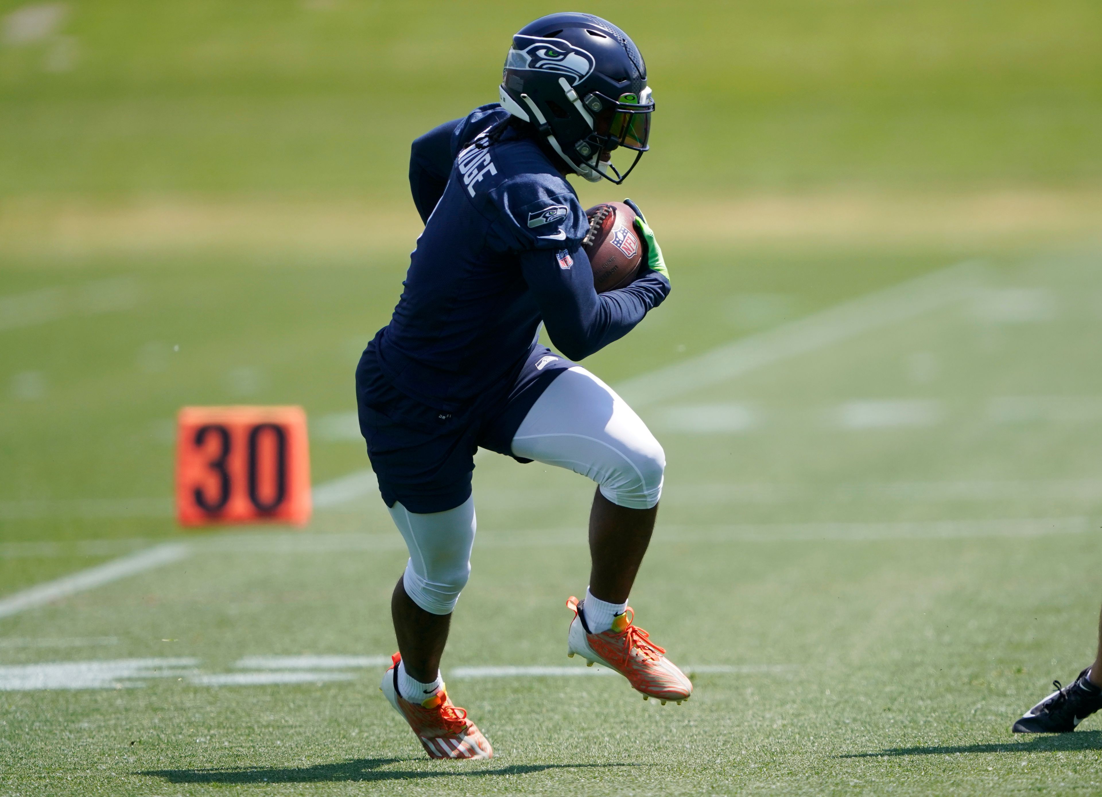 Seattle Seahawks wide receiver Dee Eskridge runs a drill during NFL football practice Monday, May 23, 2022, in Renton, Wash. (AP Photo/Ted S. Warren)