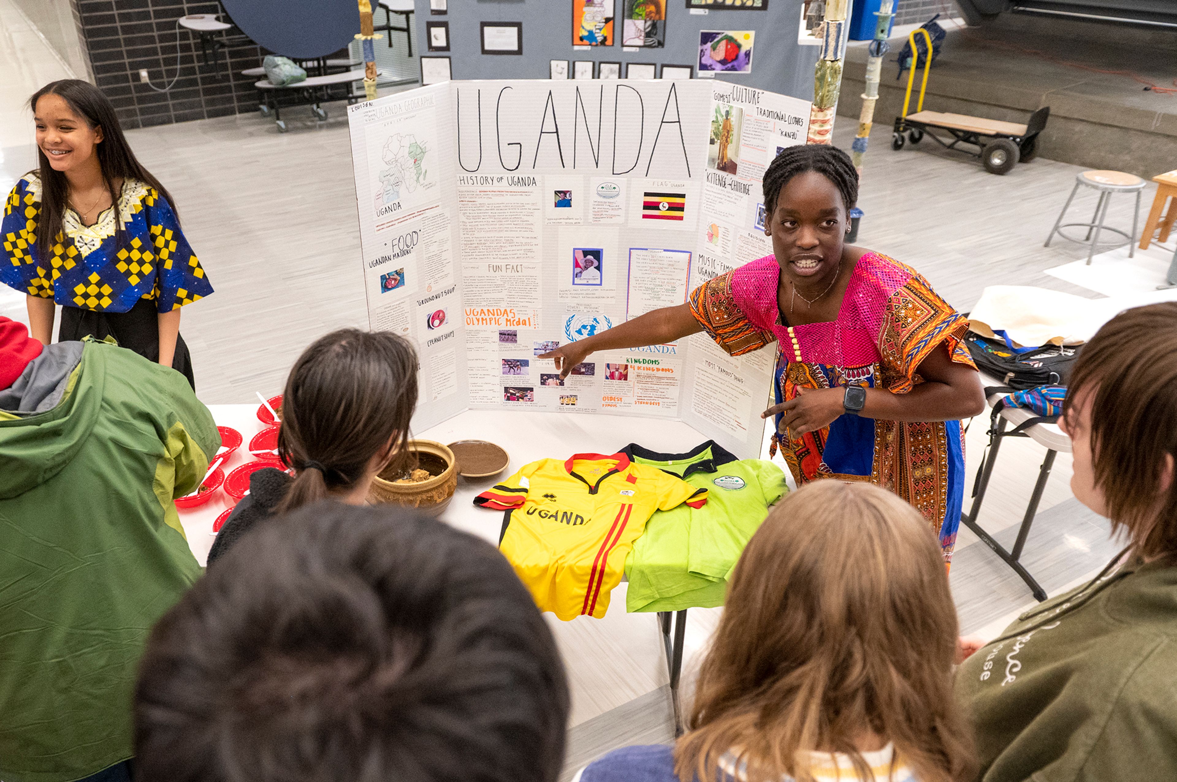 Louise Najjuuko, a junior at Pullman High School, teaches an audience about Uganda on Friday at Pullman High School’s multicultural night. “It’s been quite an amazing experience. It’s nice to know that we have many different cultures in this school and that we’re giving people a chance to learn and be more open-minded about the world,” Najjuuko said.