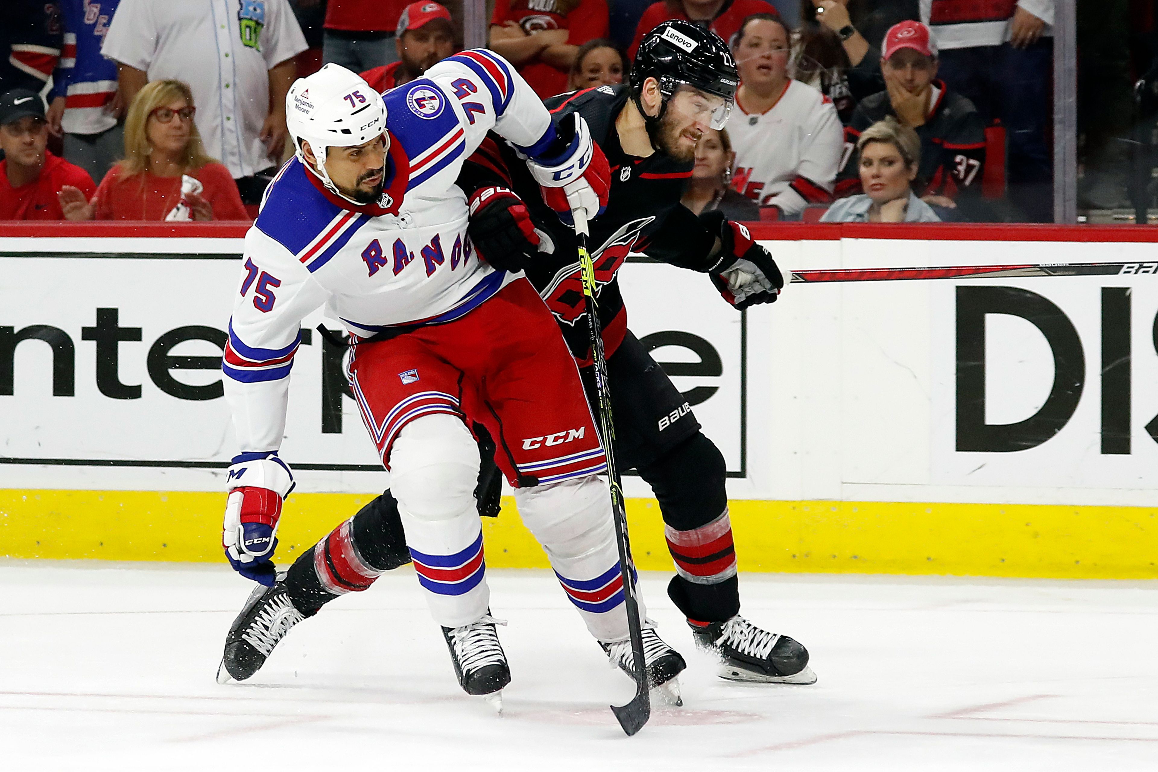 New York Rangers' Ryan Reaves (75) tangles with Carolina Hurricanes' Brett Pesce (22) during the first period of Game 7 of an NHL hockey Stanley Cup second-round playoff series in Raleigh, N.C., Monday, May 30, 2022. (AP Photo/Karl B DeBlaker)