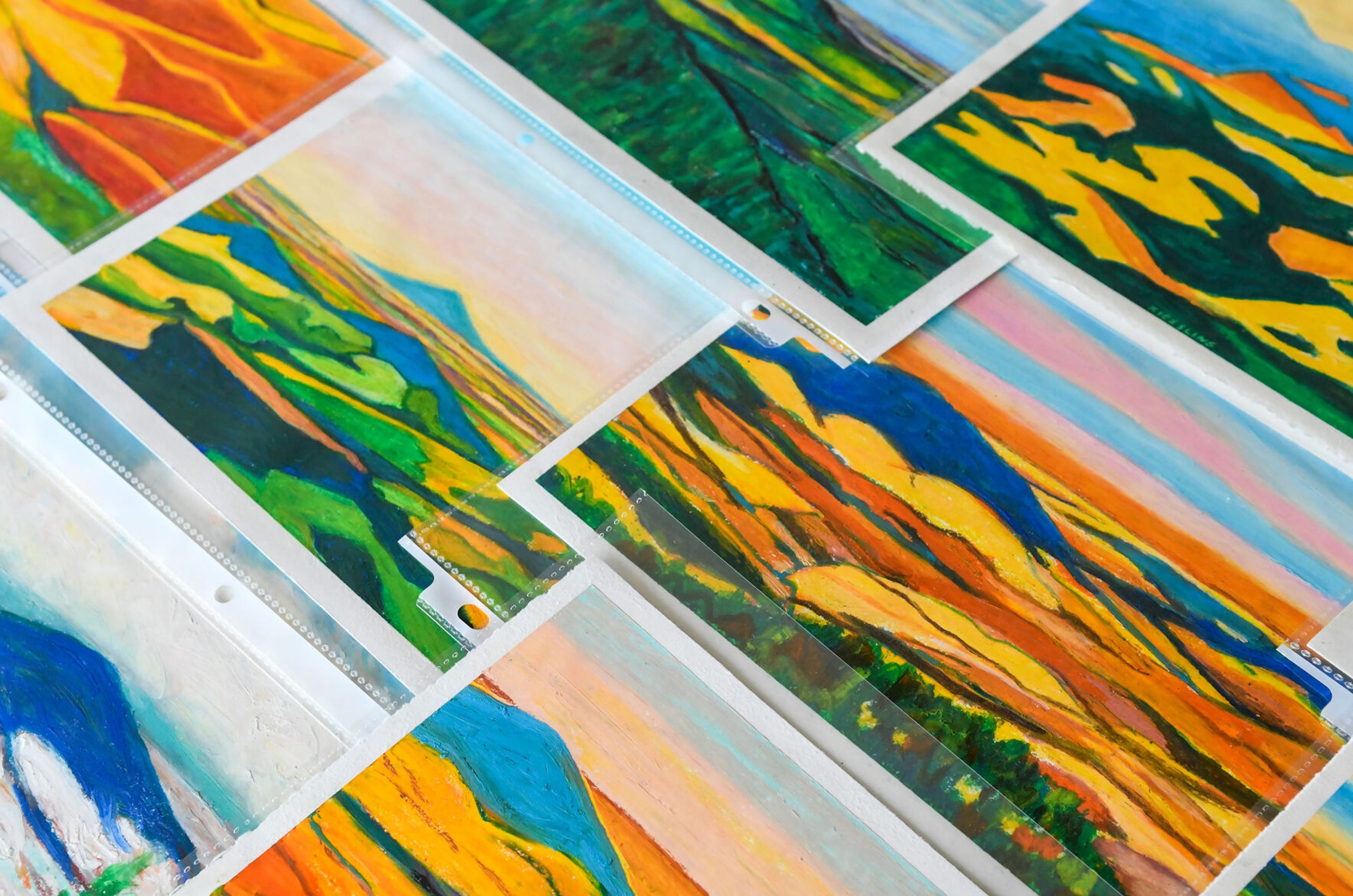 A collection of Dan Kiessling’s Palouse County pastels are laid out in his parent’s home in Pullman on Tuesday. Similar pieces will be shown at a celebration of life art show in his honor on June 22 at the Bank Left Art Gallery in Palouse.