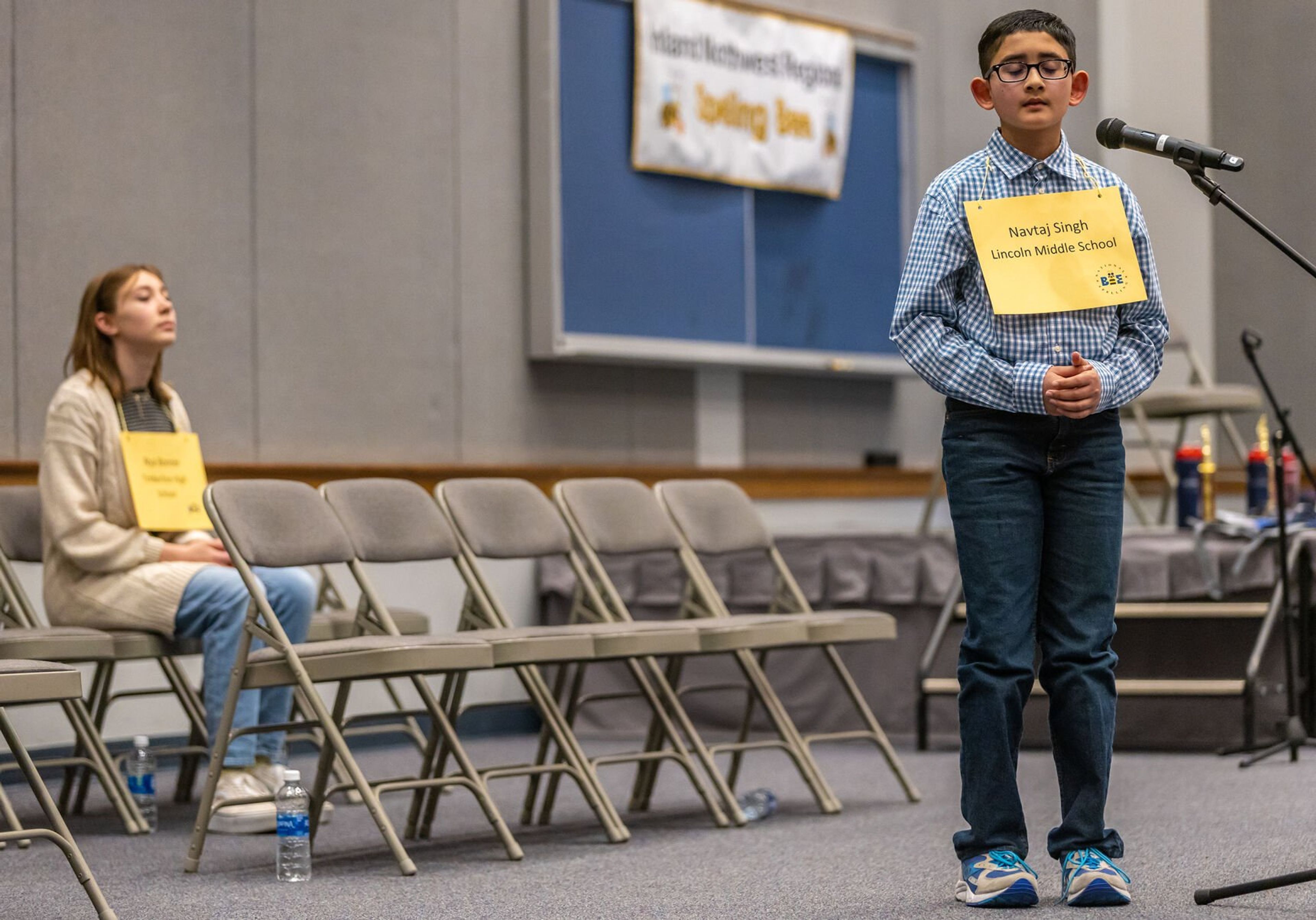 Champion speller Navtaj Singh, right, of Lincoln Middle School, concentrates on the spelling of his next word as Nya Bonner waits for her turn at the title Saturday during the Inland Northwest Regional Spelling Bee at Lewis-Clark State College in Lewiston. Singh’s winning word was clearance and will soon be heading to Washington D.C. to represent the Inland Northwest on the national spelling bee stage.