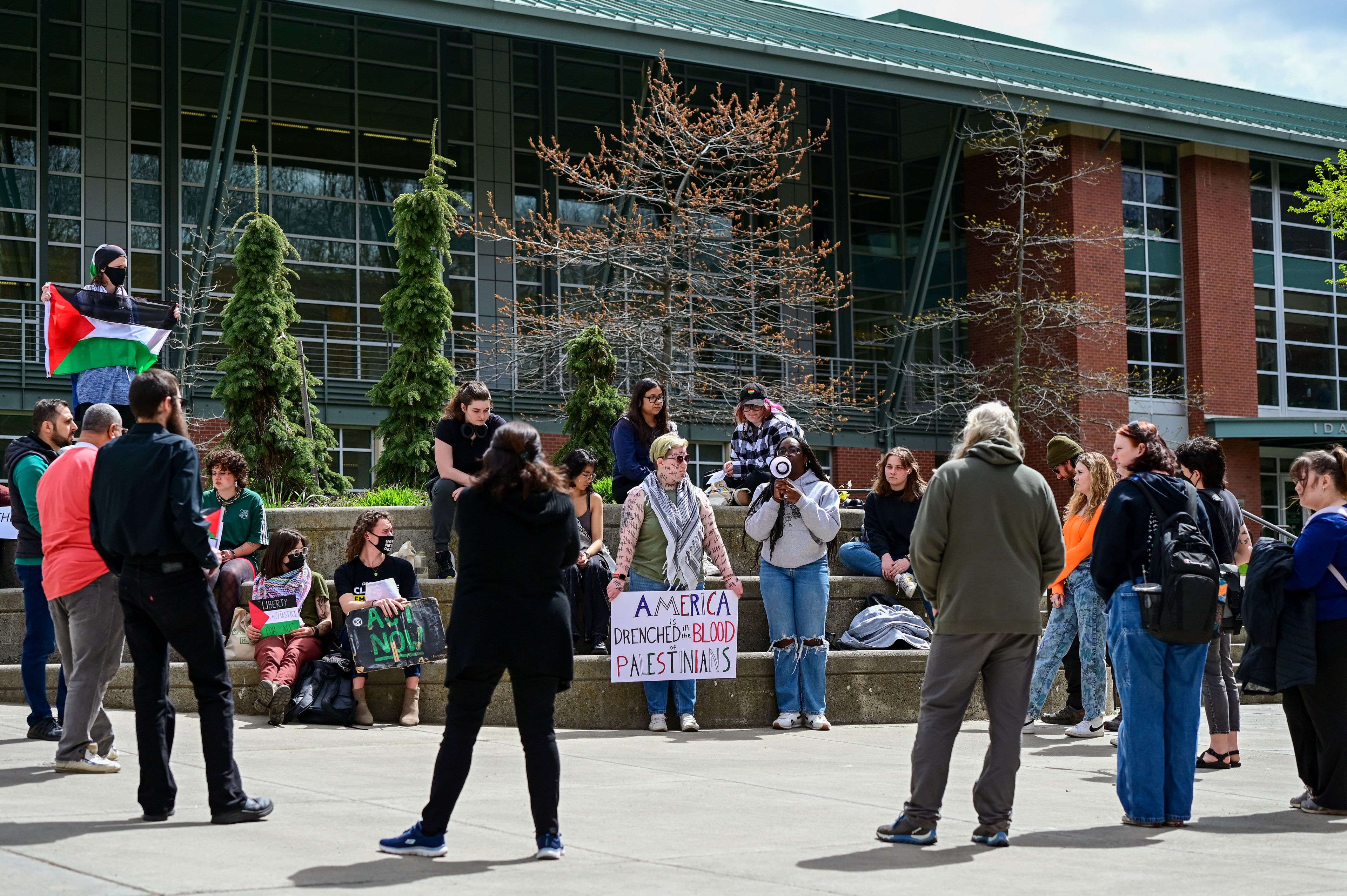 Seyi Arogundade, right, a University of Idaho student and incoming vice president of the Black Student Union at UI, speaks to the group gathered at the pro-Palestine demonstration on campus in Moscow on Thursday.