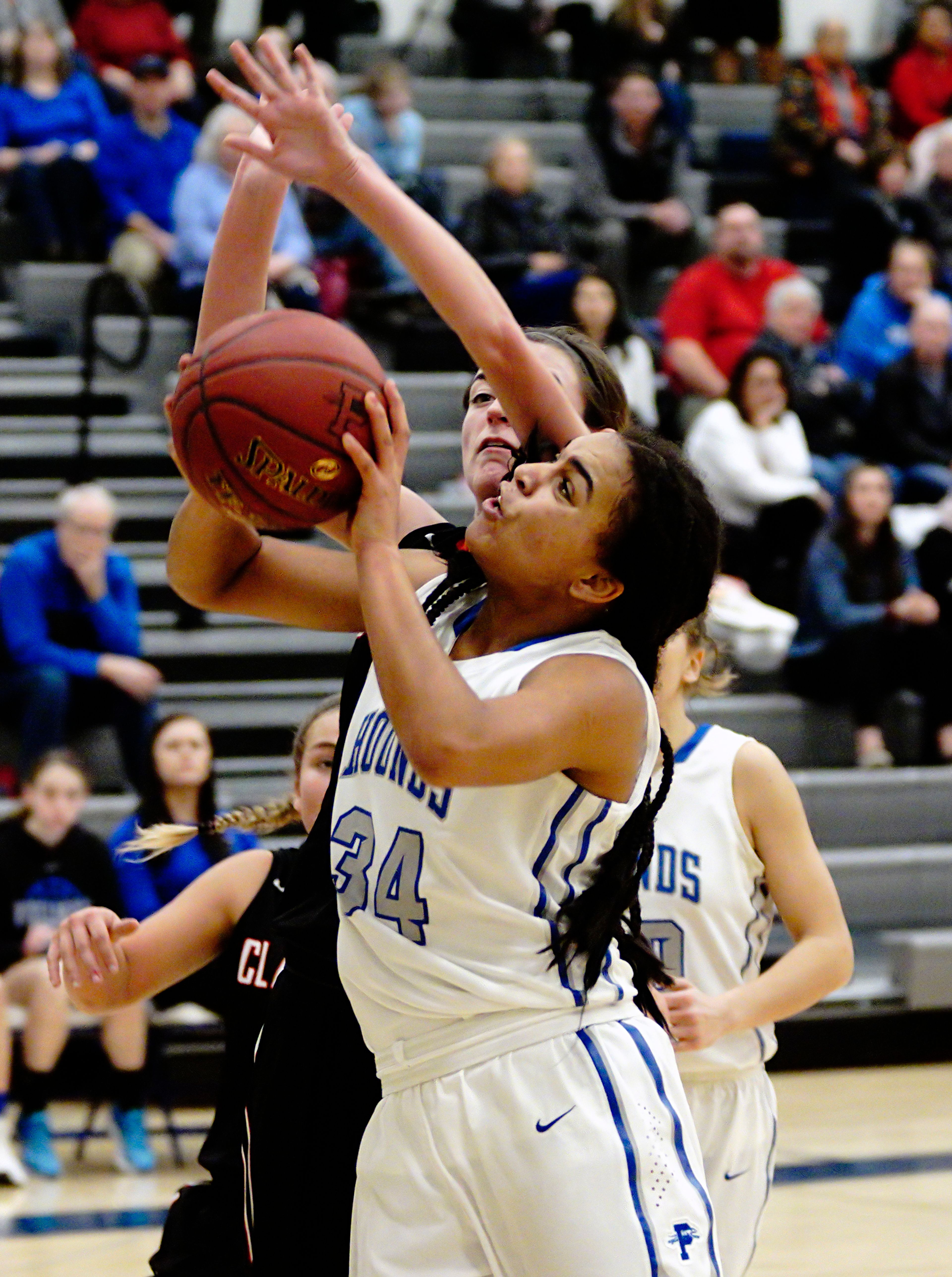 Pullman's Alexus Haugen (34) tries to put up a shot against Clarkston's Makinzie Packwood during a game in Pullman on Friday night.