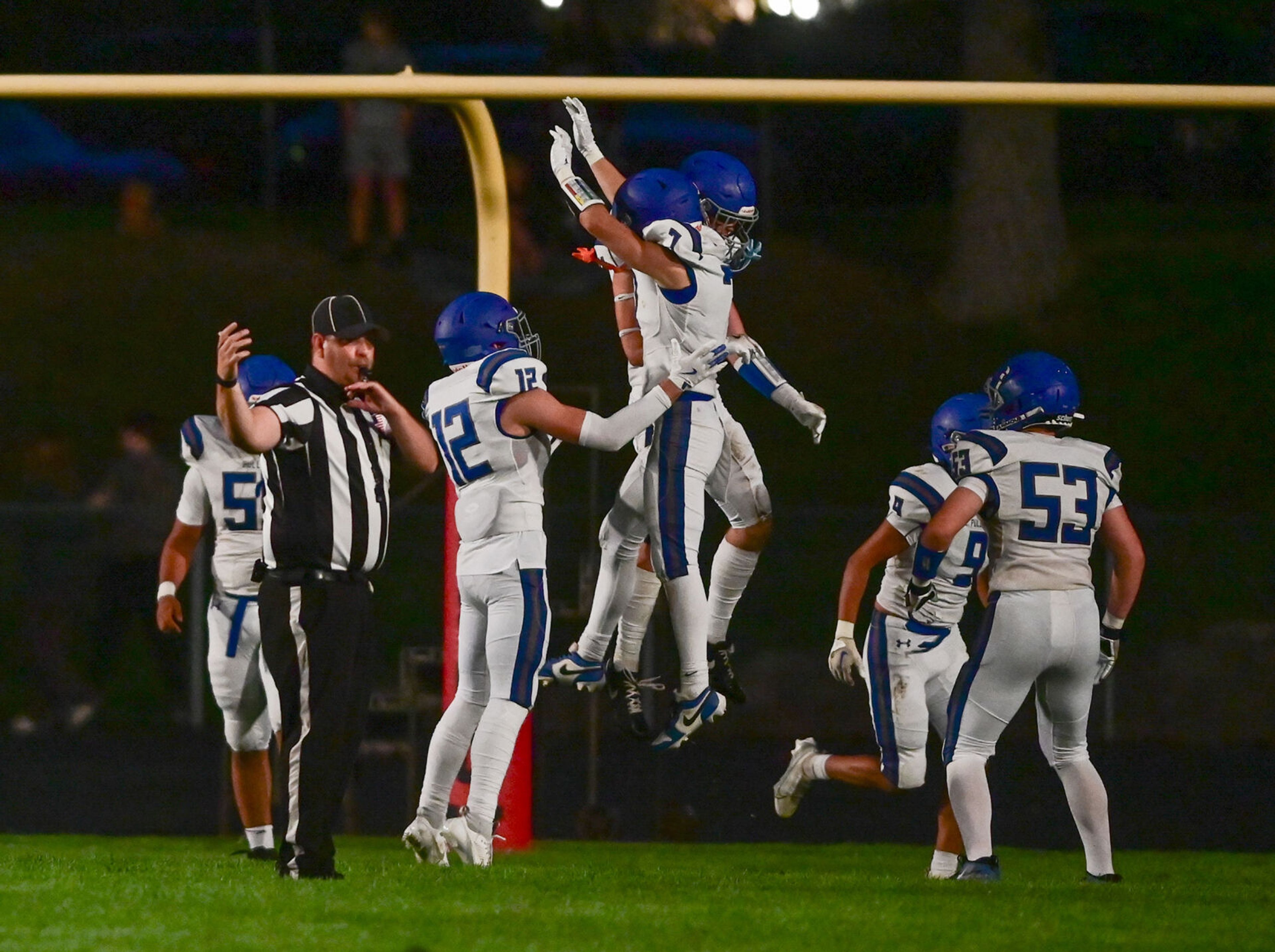 Pullman celebrates their first touchdown against Moscow in the end zone Friday in Moscow.