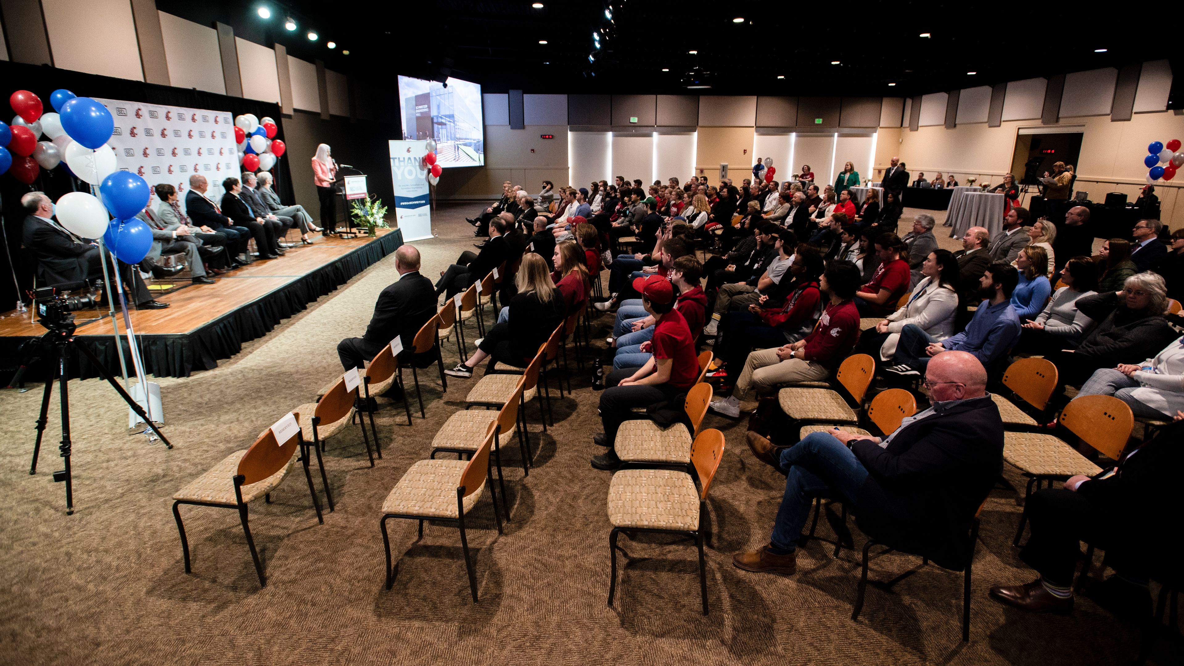 An audience listens to Dean Mary Rezac, of Washington State University’s Voiland College of Engineering and Architecture, as she discusses the long-standing relationship of Schweitzer Engineering Laboratories and WSU.