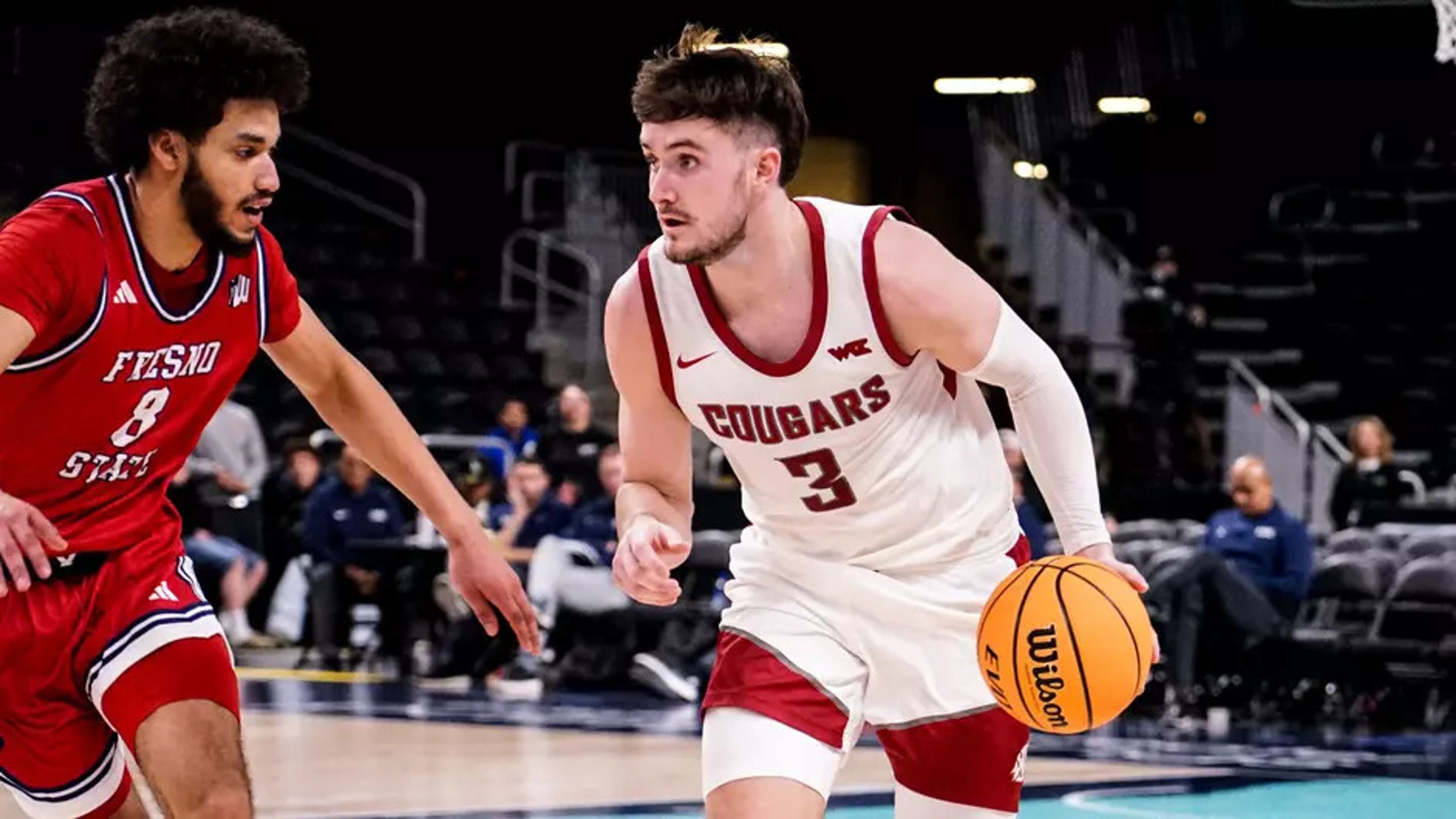 Washington State's Ethan Price (3) dribbles against Fresno State's Alex Crawford (8) during a game Tuesday in Palm Desert, Calif.