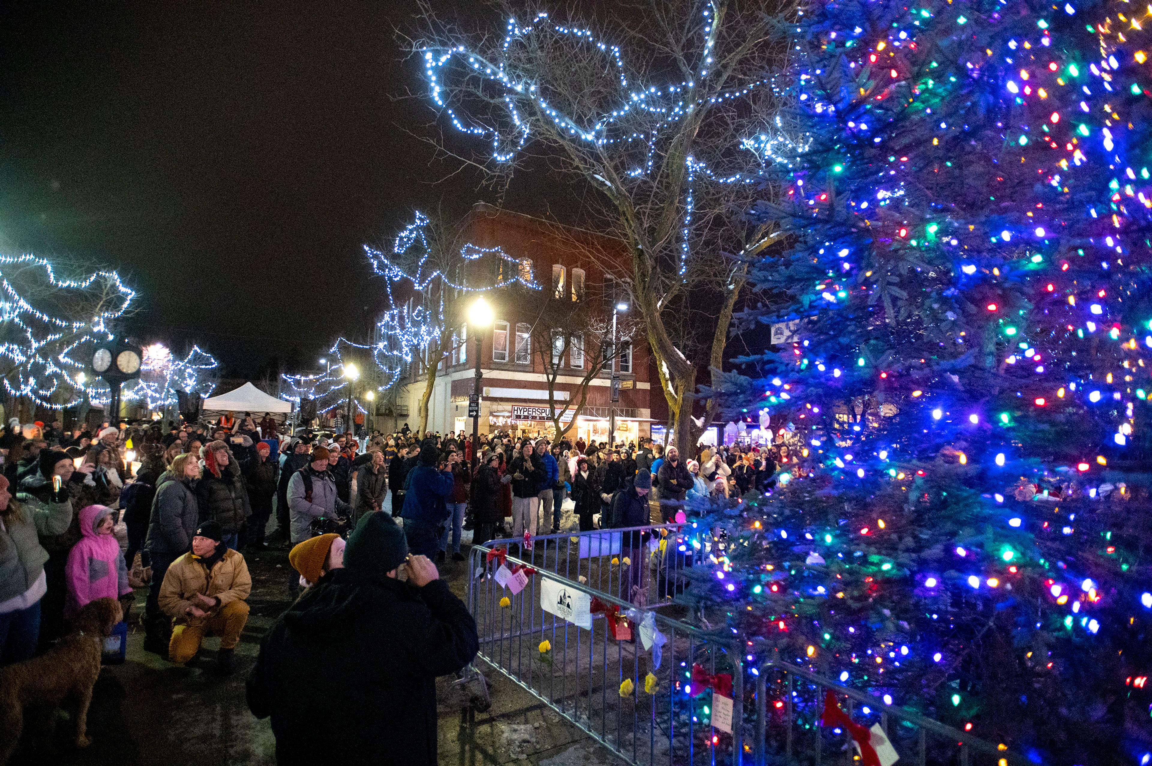 People gather around Friendship Square to watch the annual tree lighting during the Light up the Season Parade in downtown Moscow on Thursday.