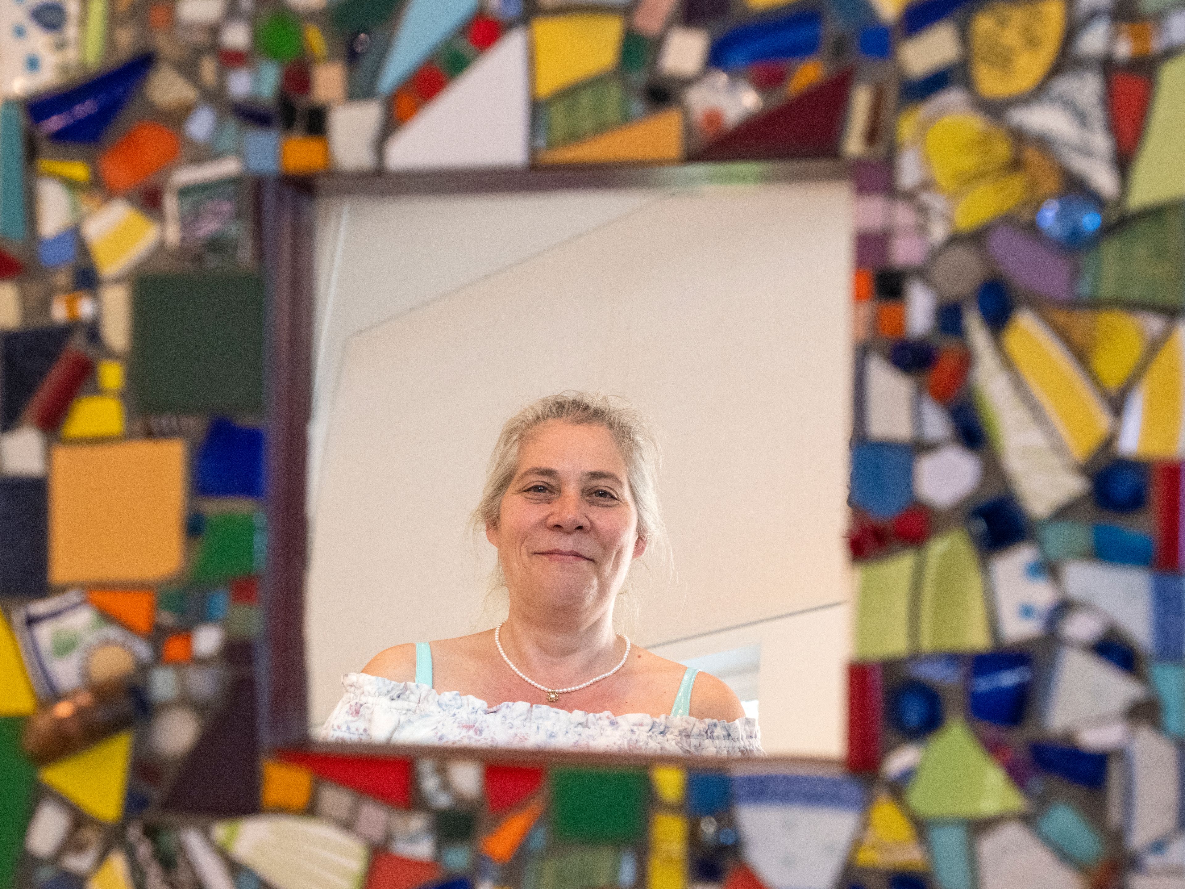 Zach Wilkinson/Daily NewsPalouse Arts Council President Shandra Bohn is reflected Friday in Lynda Darnell’s “Bottle of Red” artwork inside the Palouse Community Center for the 17th Annual Palouse ArtWalk in Palouse.