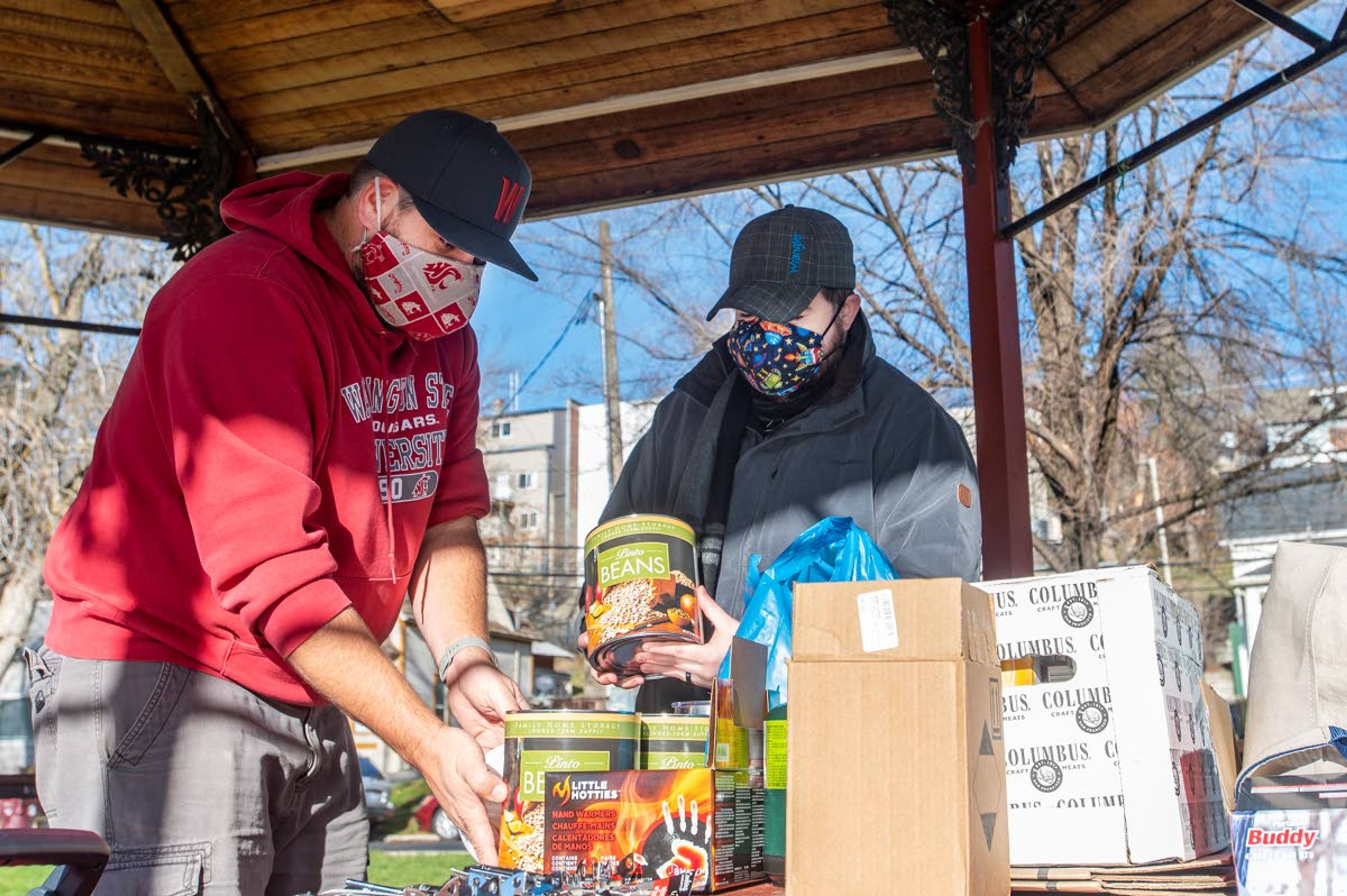 Brandon Chapman, left, donates food to the Food Security of the Palouse at Reaney Park Wednesday afternoon in Pullman.