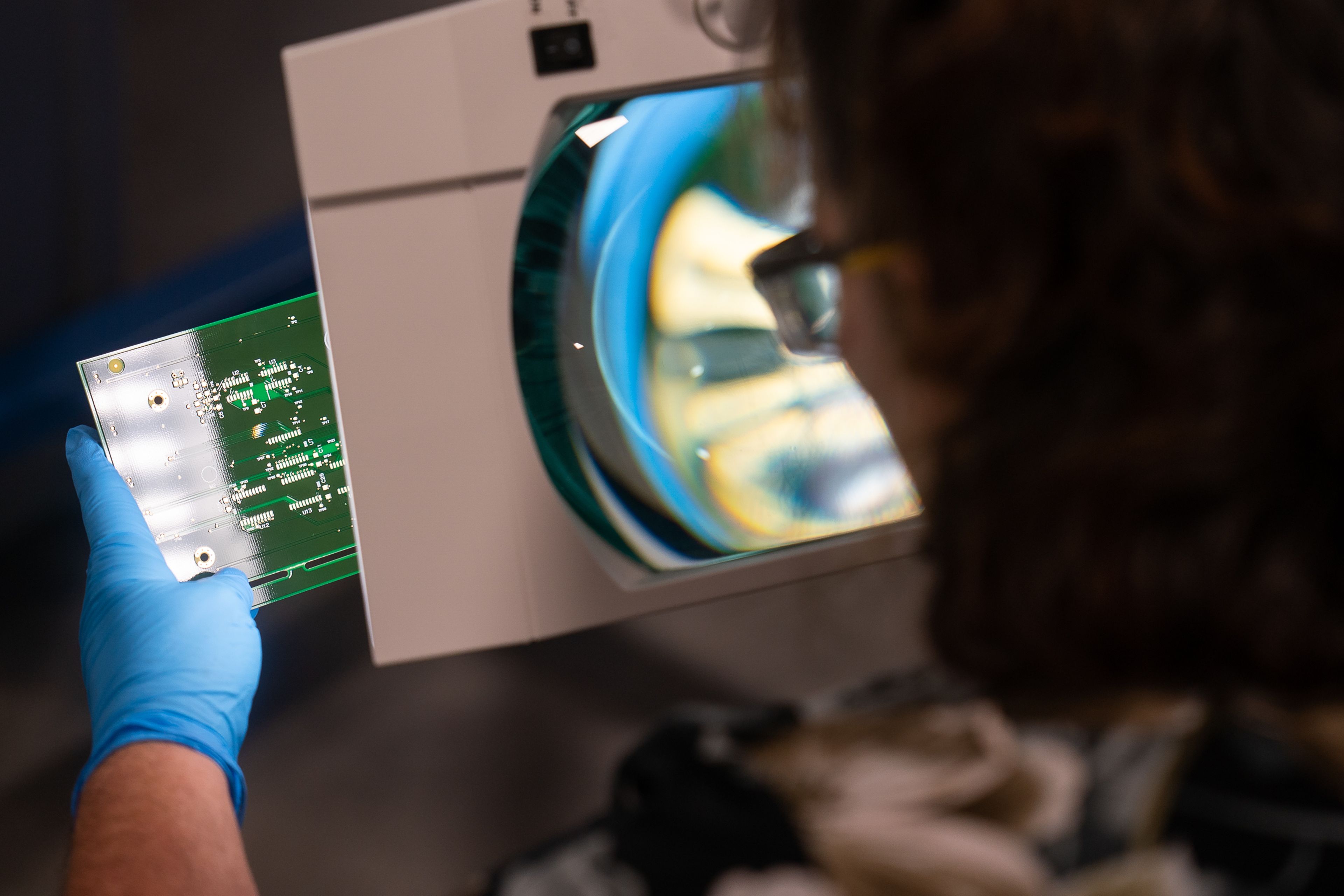 Schweitzer Engineering Laboratories employee Patty Barber preforms a final inspection on a circuit board during a tour of SEL’s new printed circuit board factory in Moscow on Wednesday.