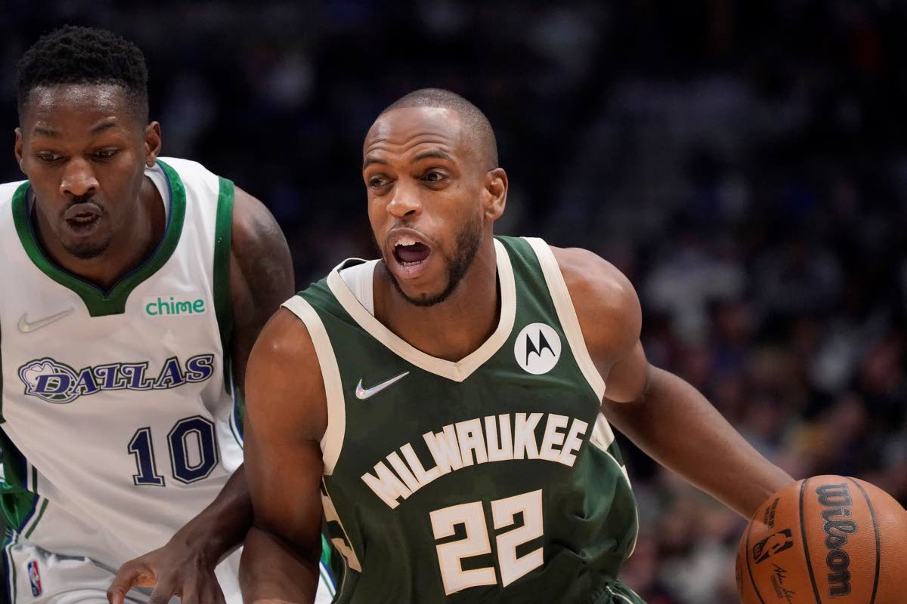 Milwaukee Bucks forward Khris Middleton (22) drives against Dallas Mavericks forward Dorian Finney-Smith (10) during the first half of an NBA basketball game in Dallas, Thursday, Dec. 23, 2021. (AP Photo/LM Otero)