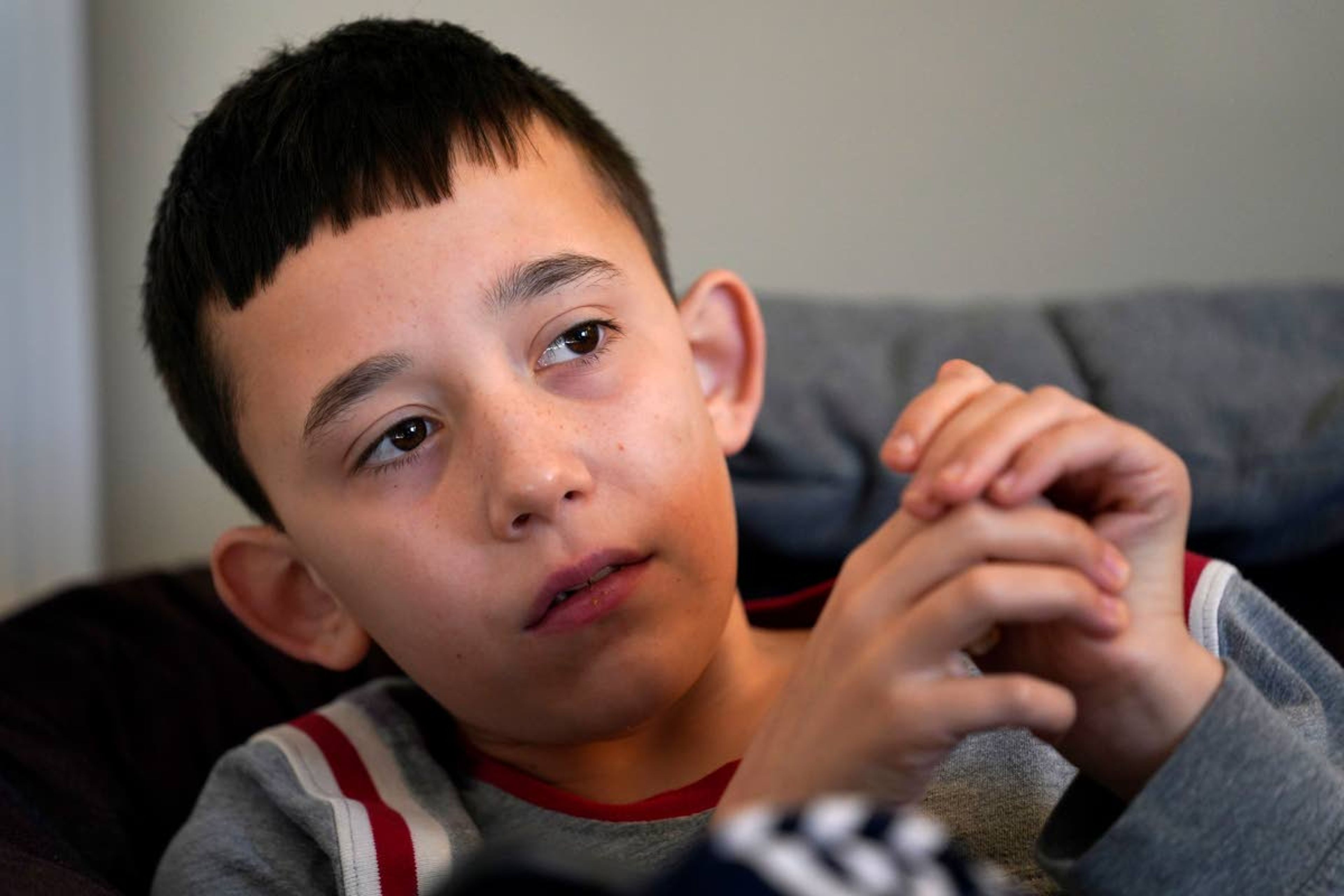 Josh Nazzaro participates in school via his laptop from his home in Wharton, N.J., Wednesday, Nov. 18, 2020. Without any in-school special education services for months, Nazzaro’s normally sweet demeanor has sometimes given way to aggressive meltdowns that had been under control before the pandemic. The teenager, who has autism and is nonverbal, often wanted no part of his online group speech therapy sessions, and when he did participate, he needed constant hands-on guidance from aides hired by his family. (AP Photo/Seth Wenig)