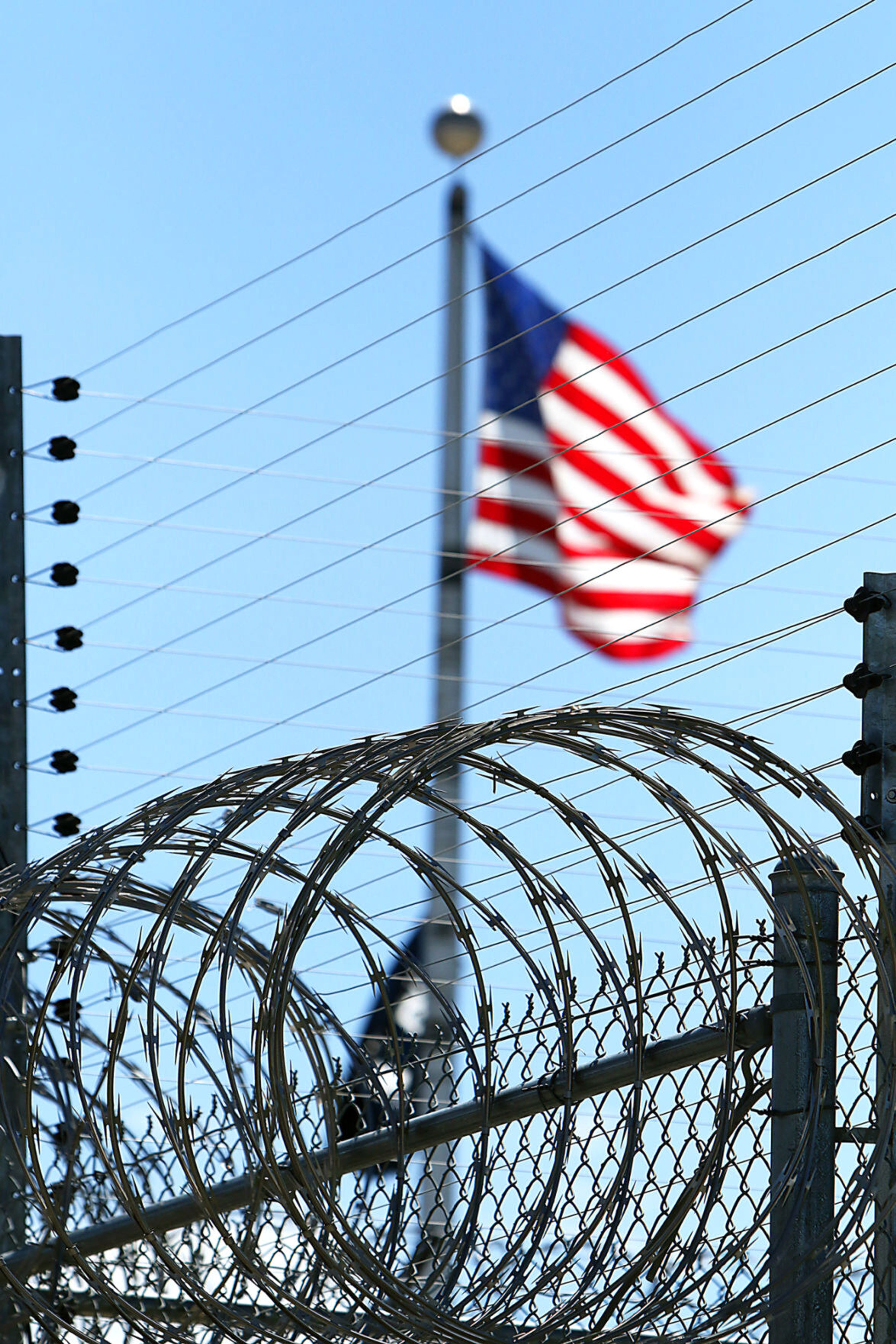 An American flag waves in a gentle breeze above the razor wire at the Idaho State Correctional Center at Kuna in this July 2019 file photo.