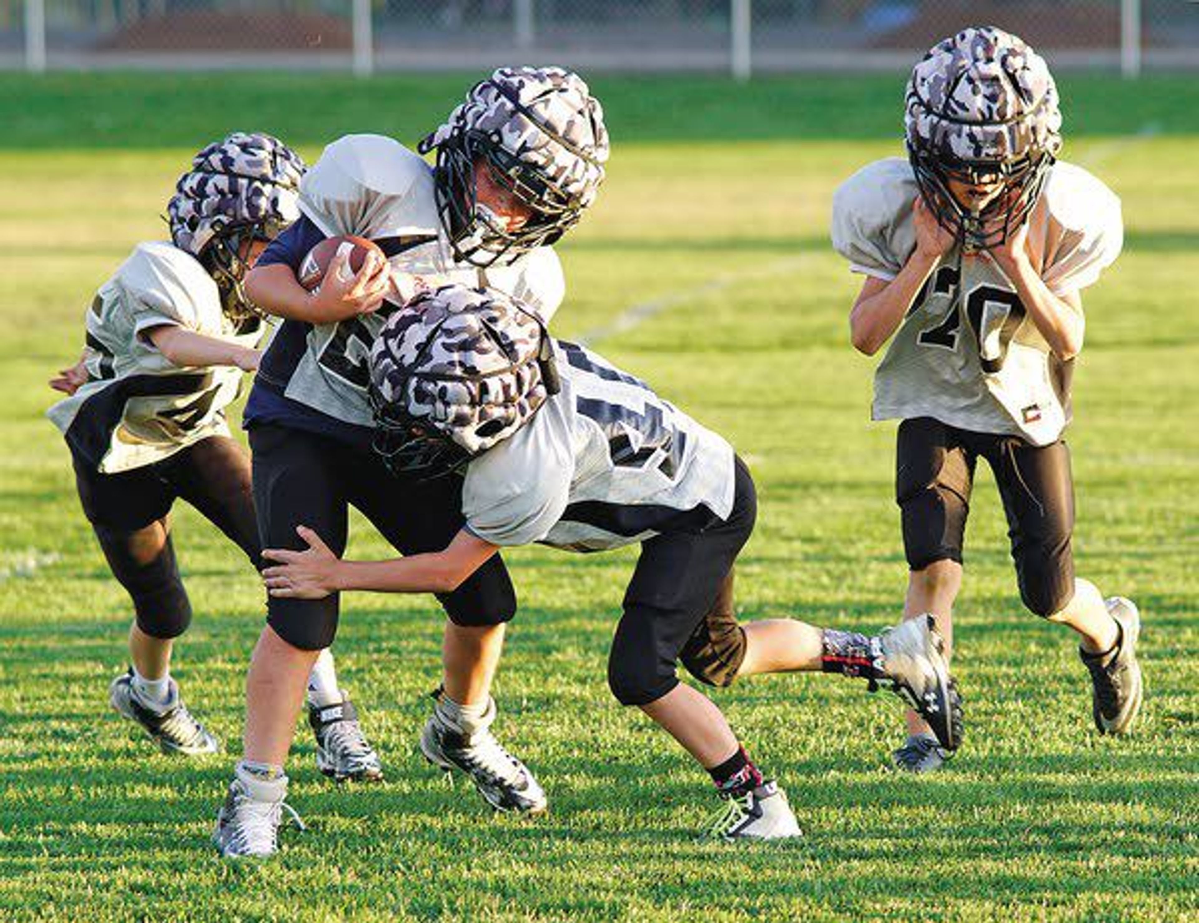 Players on the Moscow Thrashers silver team, comprised of third- and fourth-graders, practice tackling Wednesday evening.