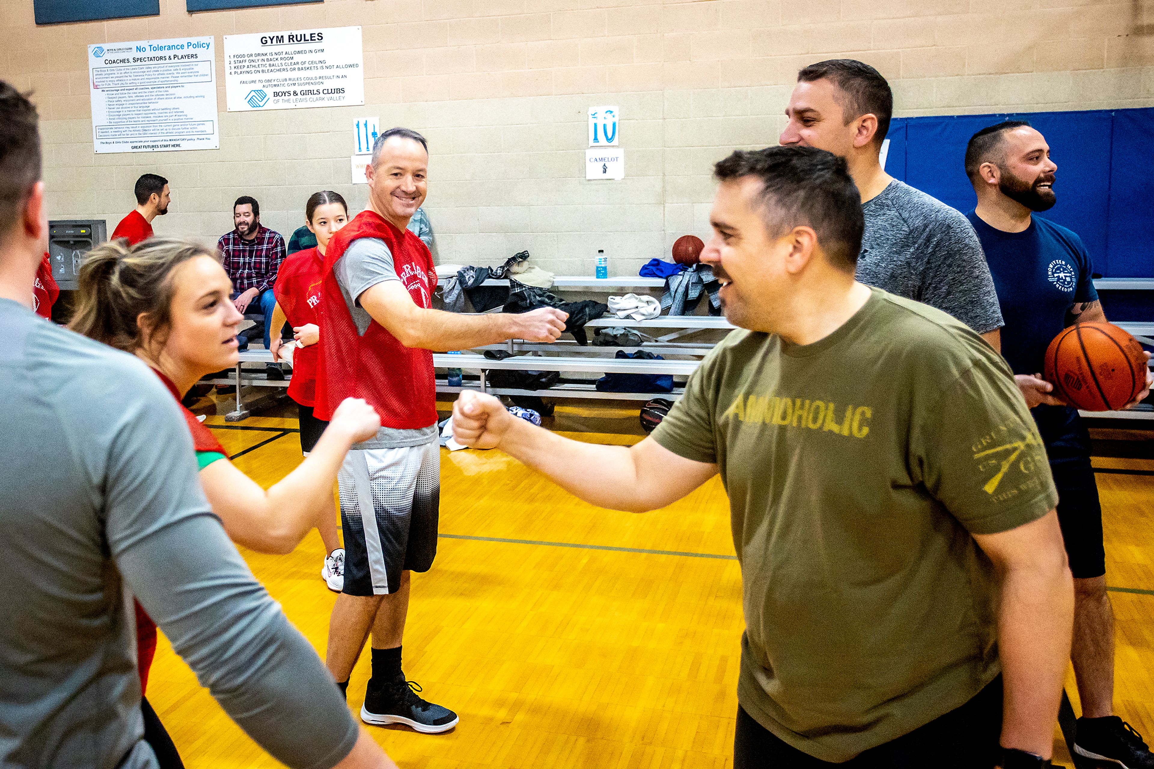 Teams bump fists before their game of Turkey Ball at the Lewiston Boys and Girls Club on Thursday.