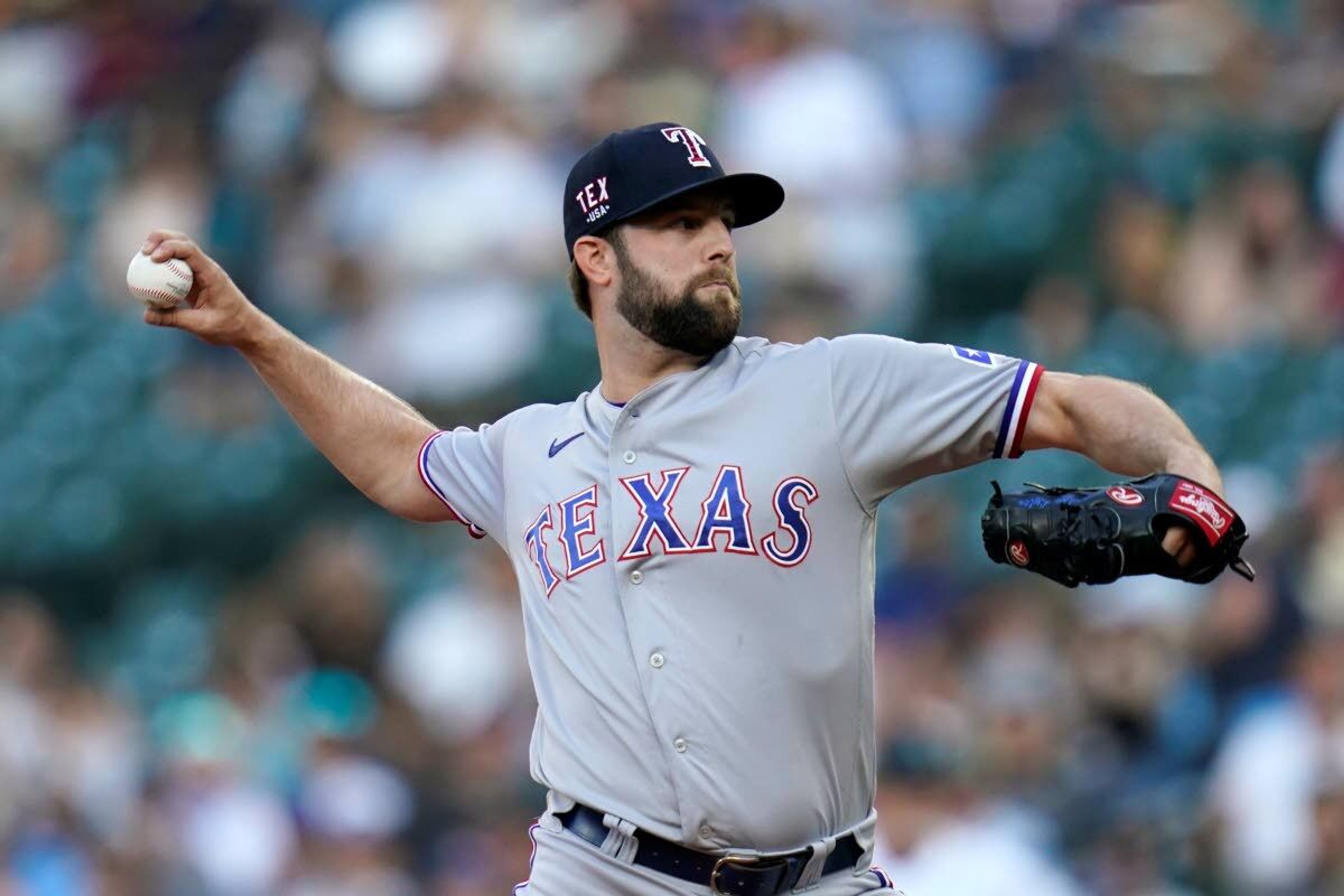 Texas Rangers starting pitcher Jordan Lyles throws to a Seattle Mariners batter during the first inning of a baseball game Saturday, July 3, 2021, in Seattle. (AP Photo/Elaine Thompson)