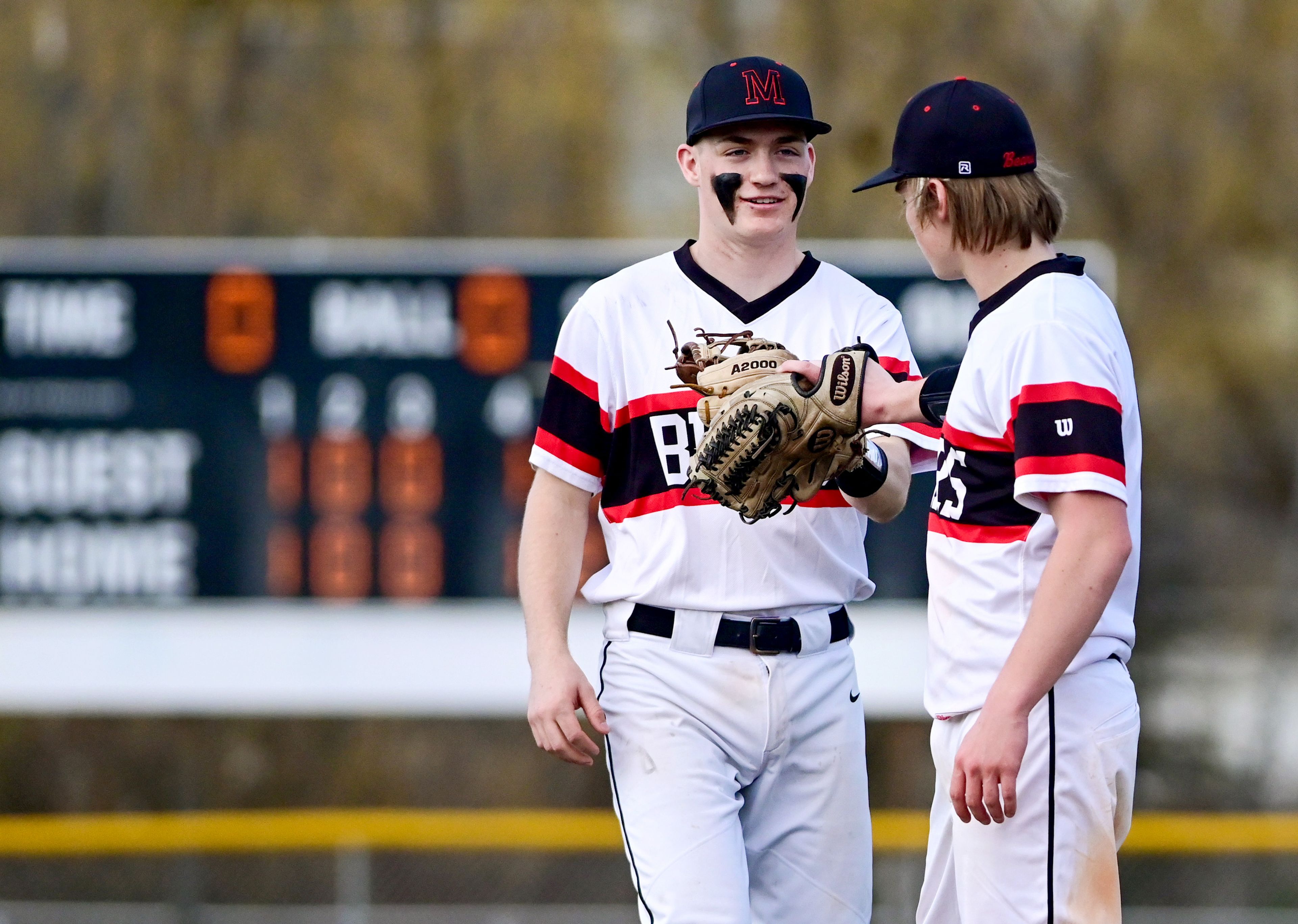 Moscow senior Jack Driskill, left, and junior Connor Isakson bump gloves in celebration of an inning-ending play.