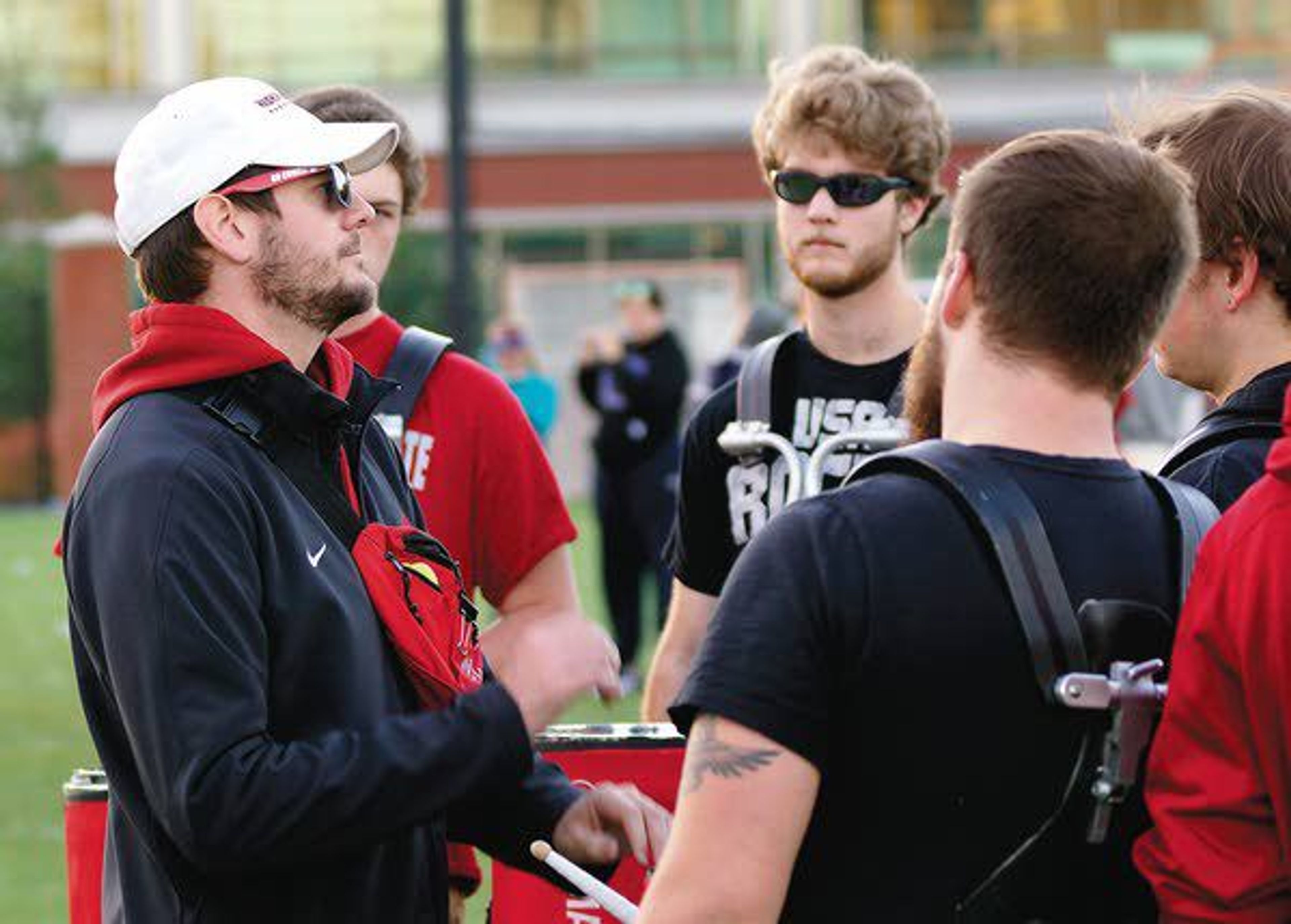 Washington State University Marching Band assistant director Brent Edwards, left, works with drummers during rehearsal Oct. 24.