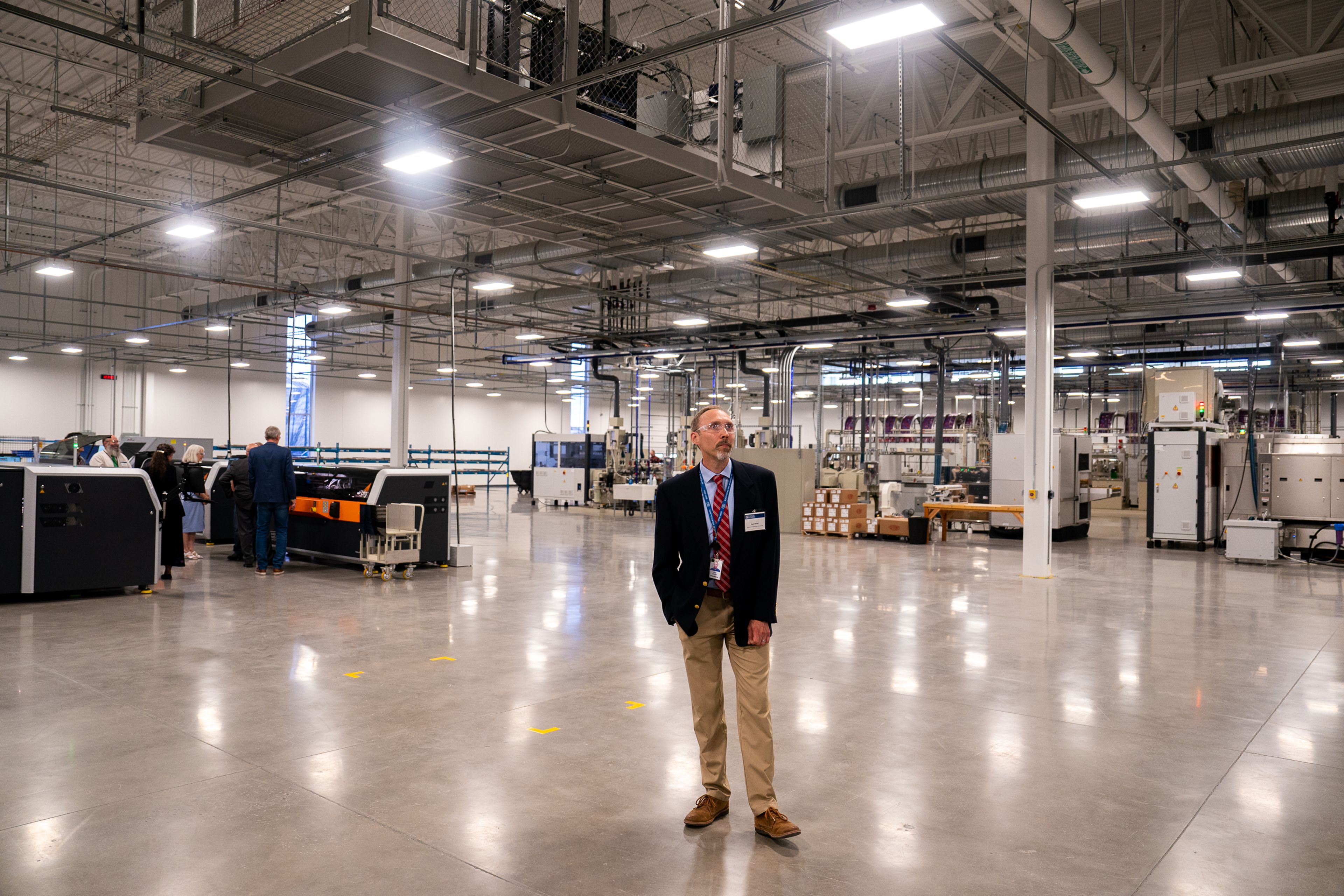 Schweitzer Engineering Laboratories employee Nate Rindal leads a group during a tour of SEL’s new printed circuit board factory in Moscow on Wednesday.