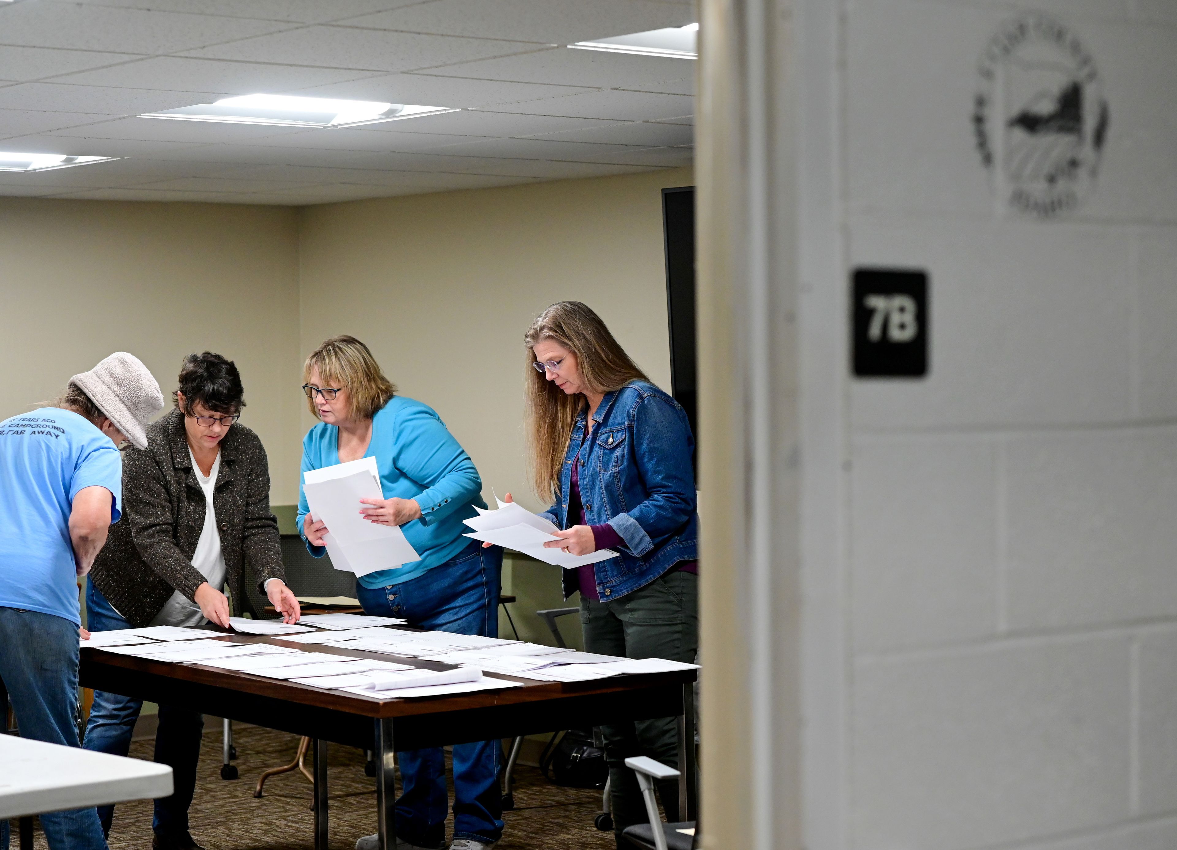 Karen Hansen, from left, Shelley Nice, Marci Mitchell, and Julie Bailey organize absentee ballots before beginning their hand count for Latah County Elections in Moscow in the afternoon on Election Day.