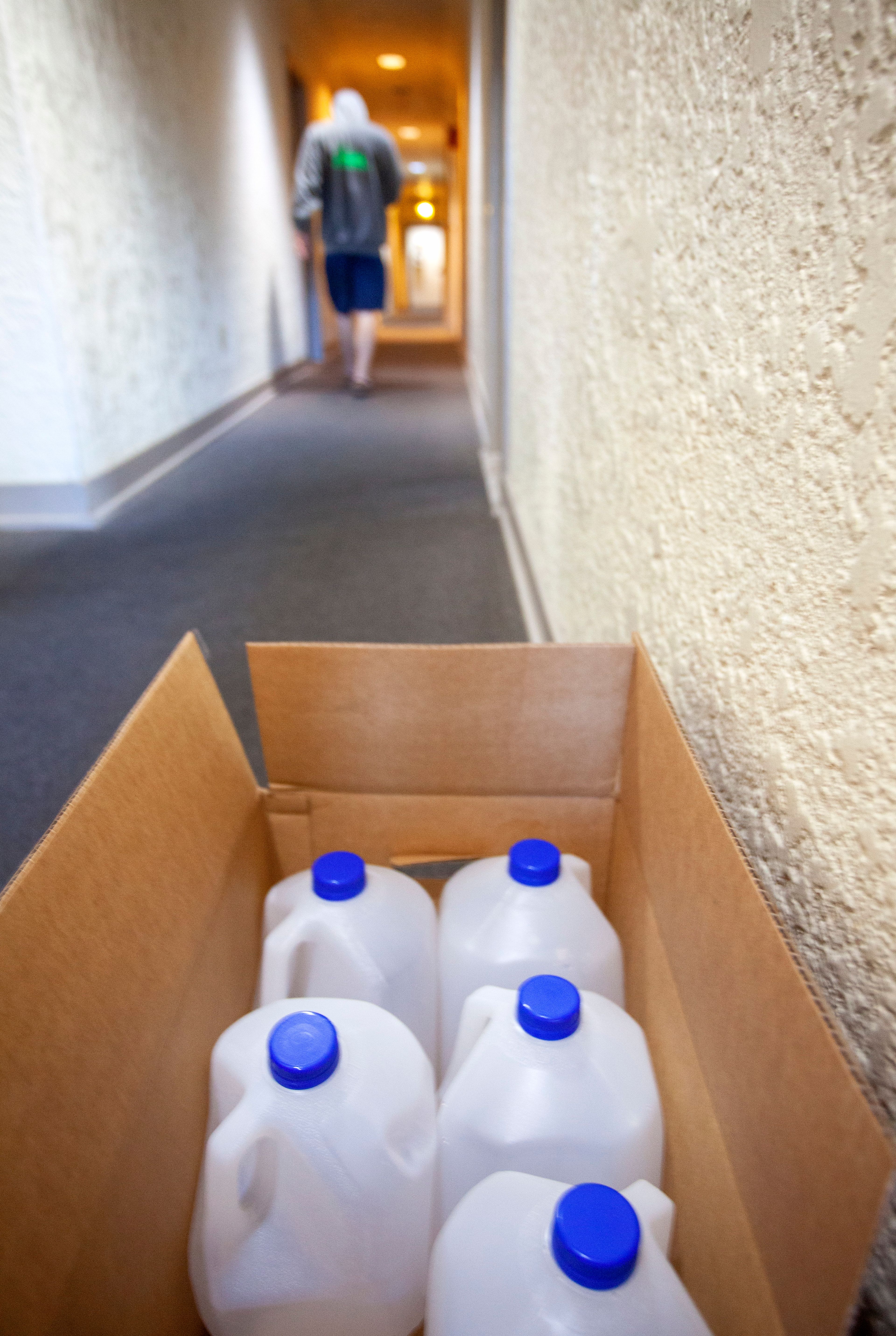 A man walks to his apartment on the third floor of the McConnell Building on Friday in downtown Moscow. Idaho Ice has been providing bottled drinking water to residents since Oct. 18 after finding elevated levels of lead and copper in the water.