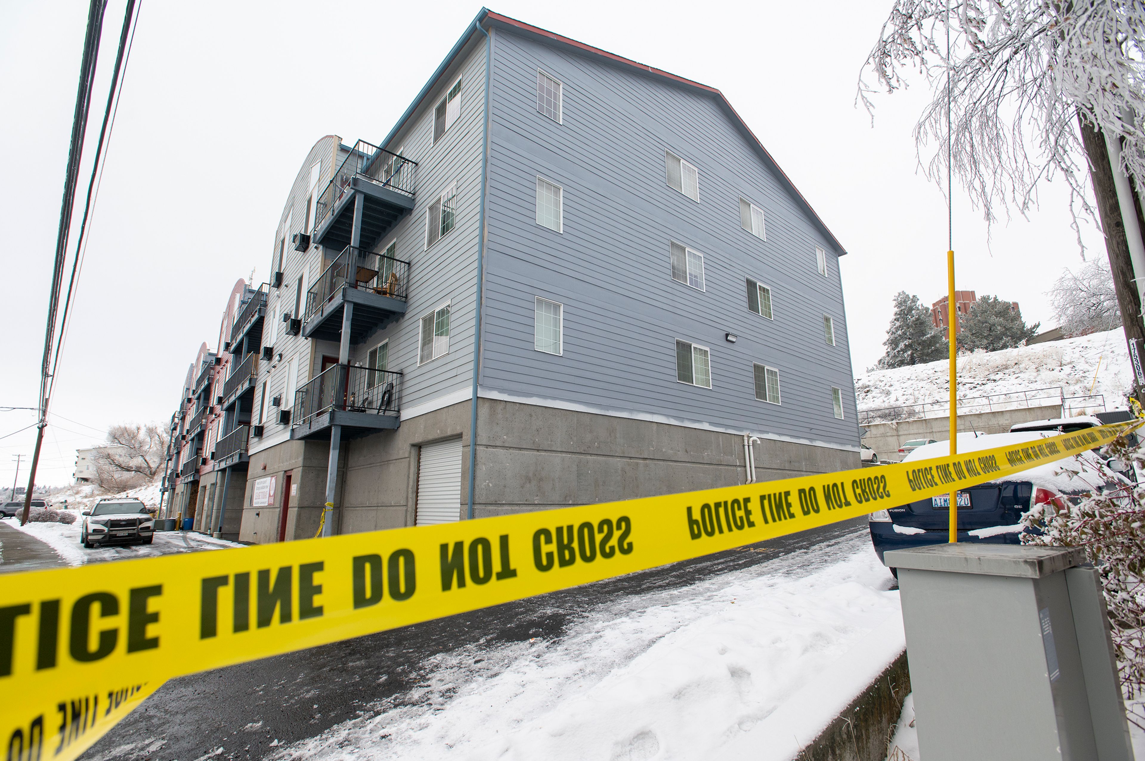 Caution tape is strung in front of the Coffee House Apartment complex Thursday where a member of the Whitman County Regional SWAT Team shot and killed a man in a standoff early Thursday morning, according to a Pullman Police Department news release.