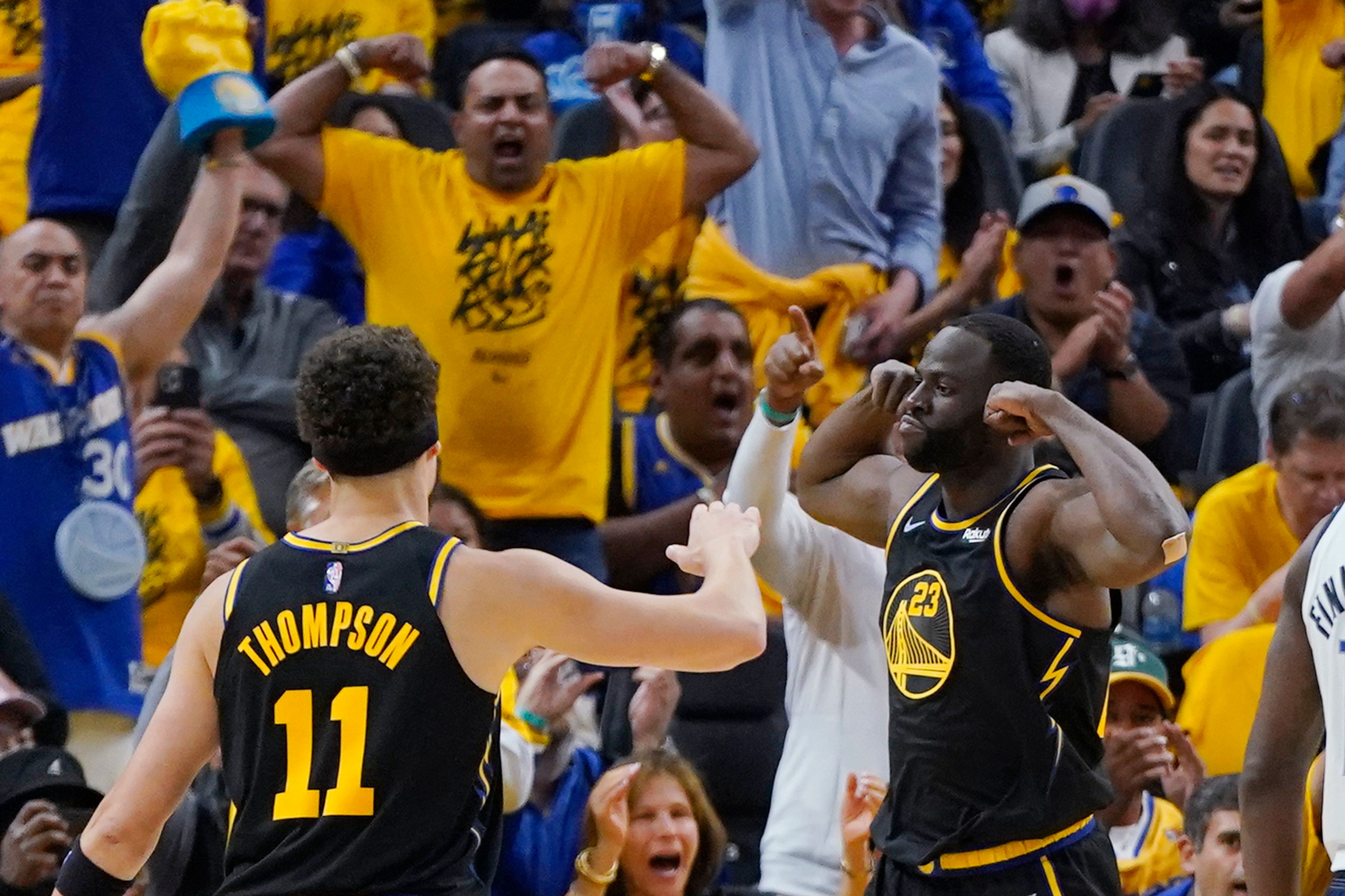 Warriors’ Draymond Green (23) celebrates with Klay Thompson during Game 5 of the Western Conference finals Thursday in San Francisco.