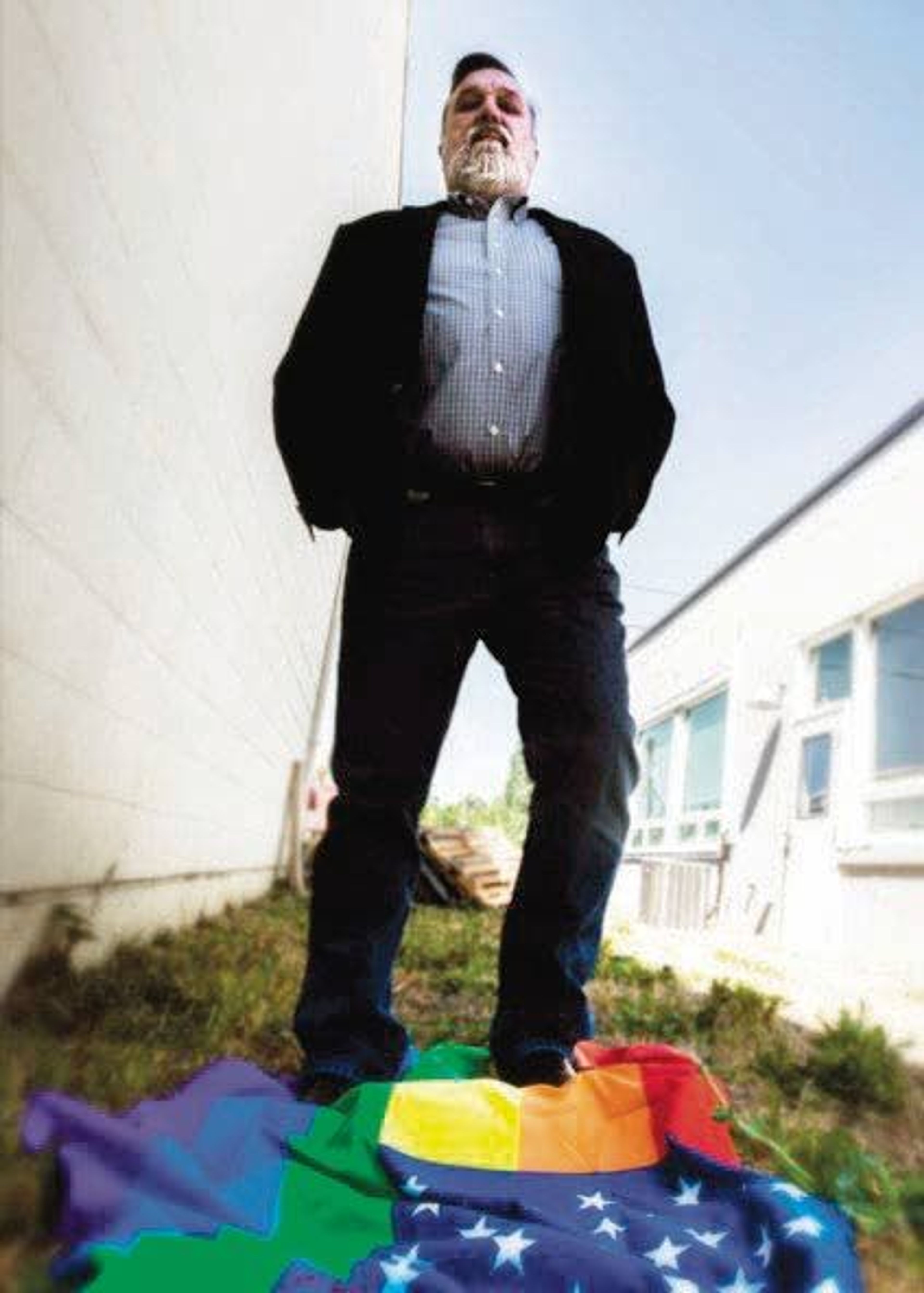 Doug Wilson, senior minister of Christ Church in Moscow, stands atop a flag incorporating the LGBT rainbow stripes.