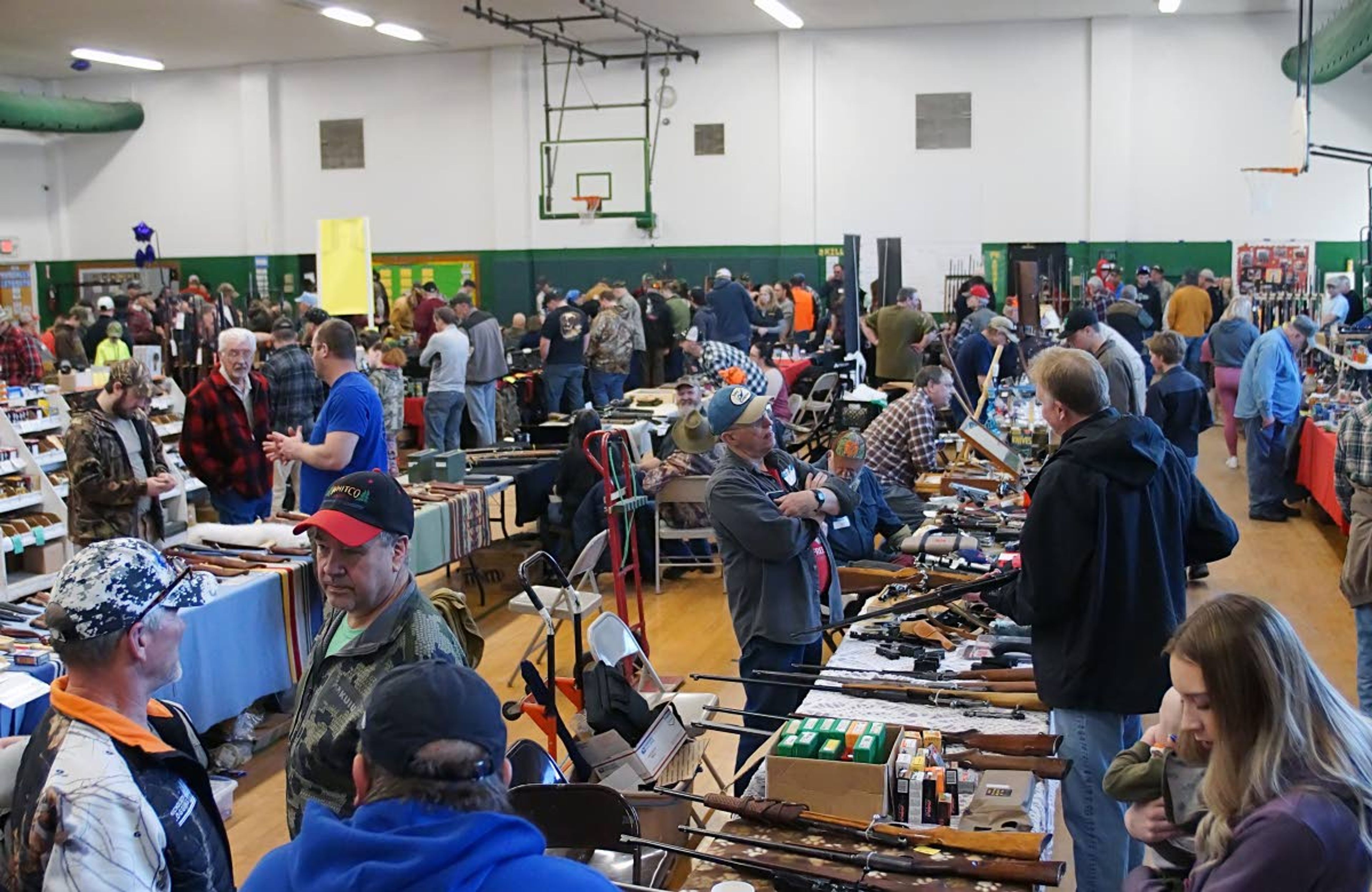 People visit and browse the items for sale at the Potlatch Gun Show Sunday morning.