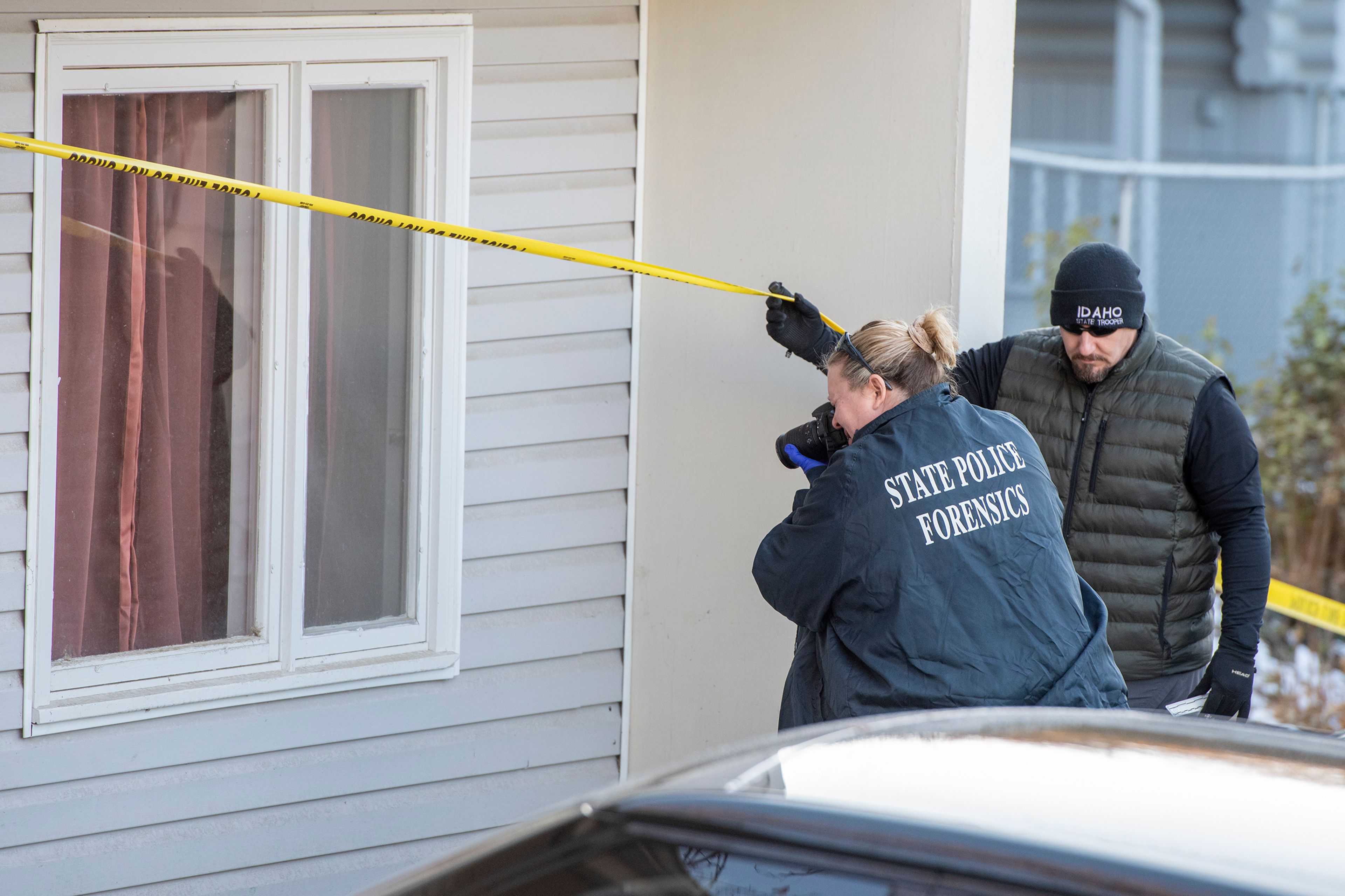 Members of the Idaho State Police forensic team investigate Friday at a home where four University of Idaho students were recently murdered over the weekend in Moscow.