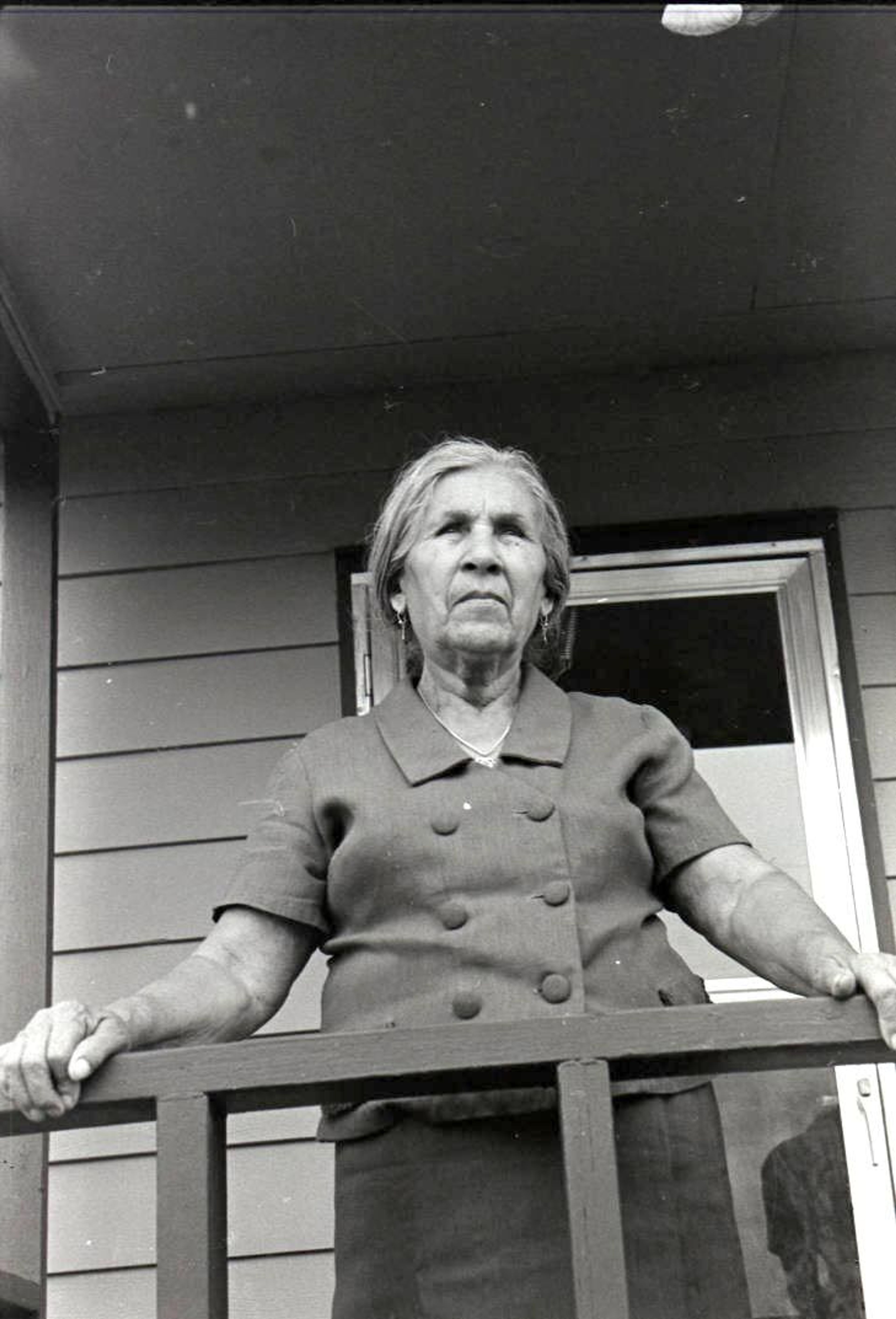 Guadalupe Gamboa's mother, Martina Molina Gamboa, stands on a porch in 1971. The image is among thousands taken by Seattle photographer Irwin Nash of migrant agricultural workers in the valley in the 1960s and 1970s.