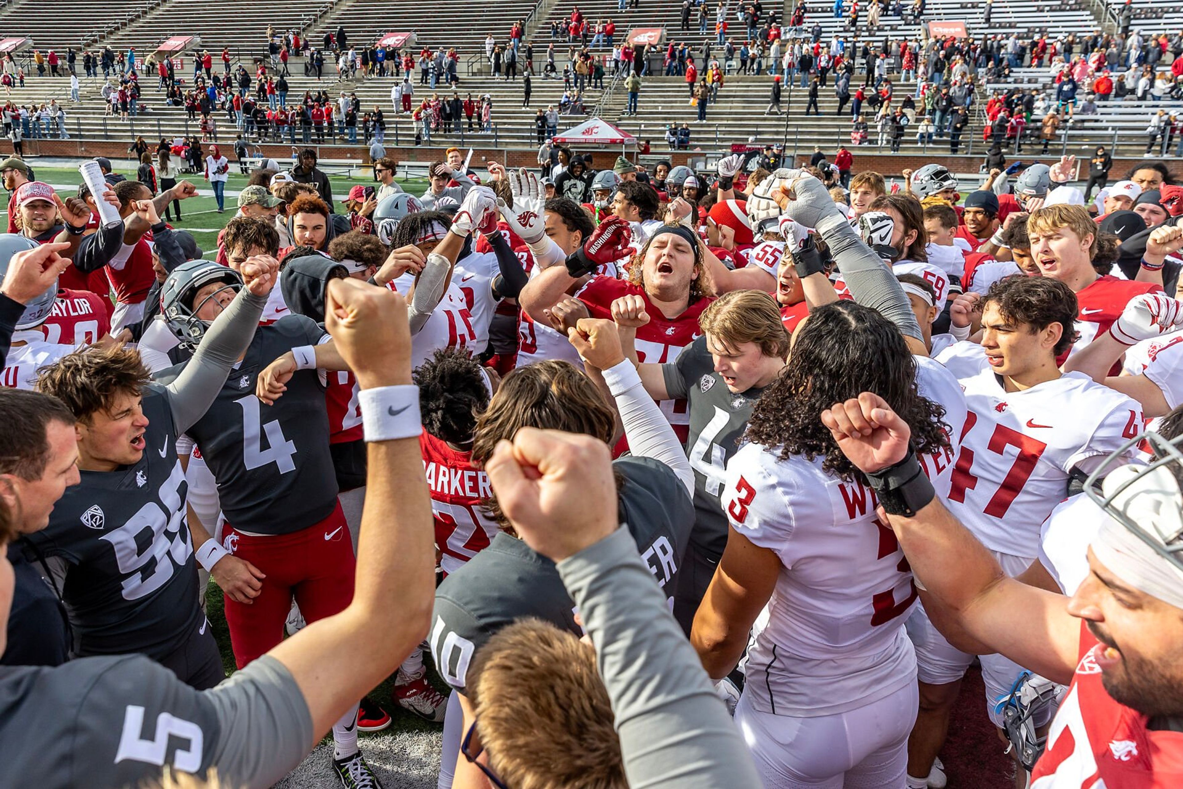 Washington State players put their fists in following the Crimson and Gray Game at Washington State University in Pullman.