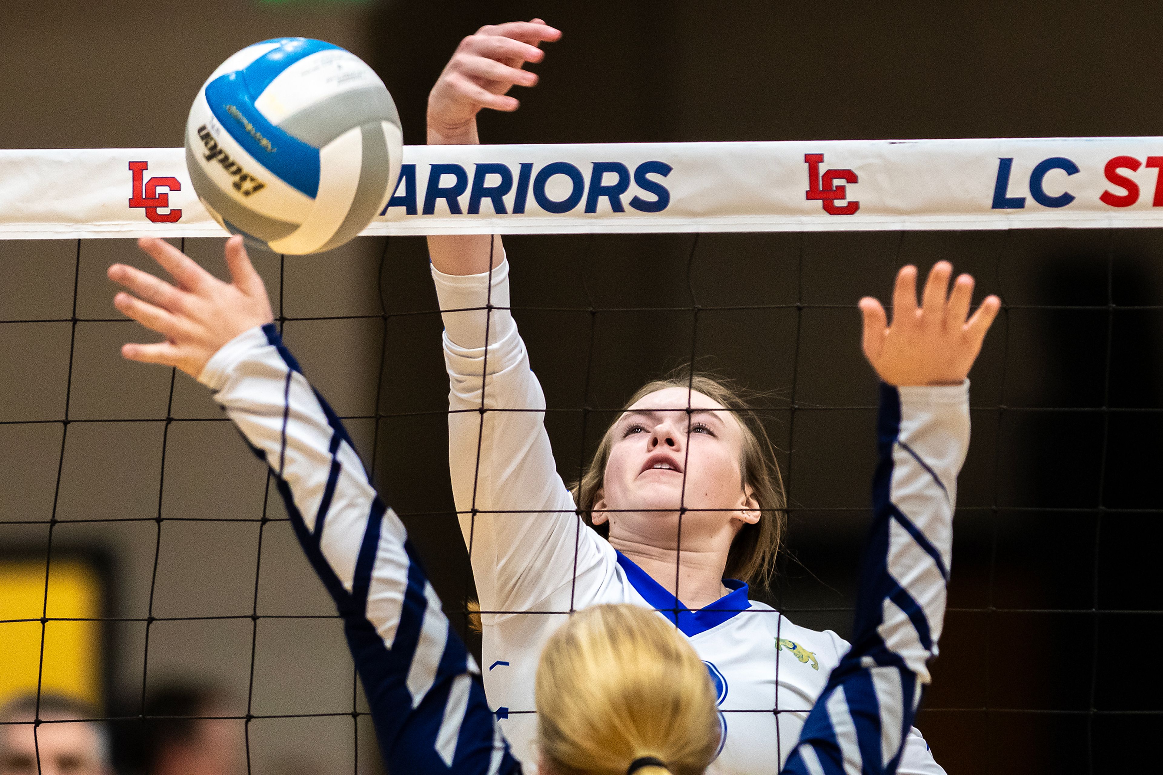 Genesee setter Kendra Meyer tips the ball over the net against St. John Bosco in a 1A district championship Thursday at the P1FCU Activity Center in Lewiston.,