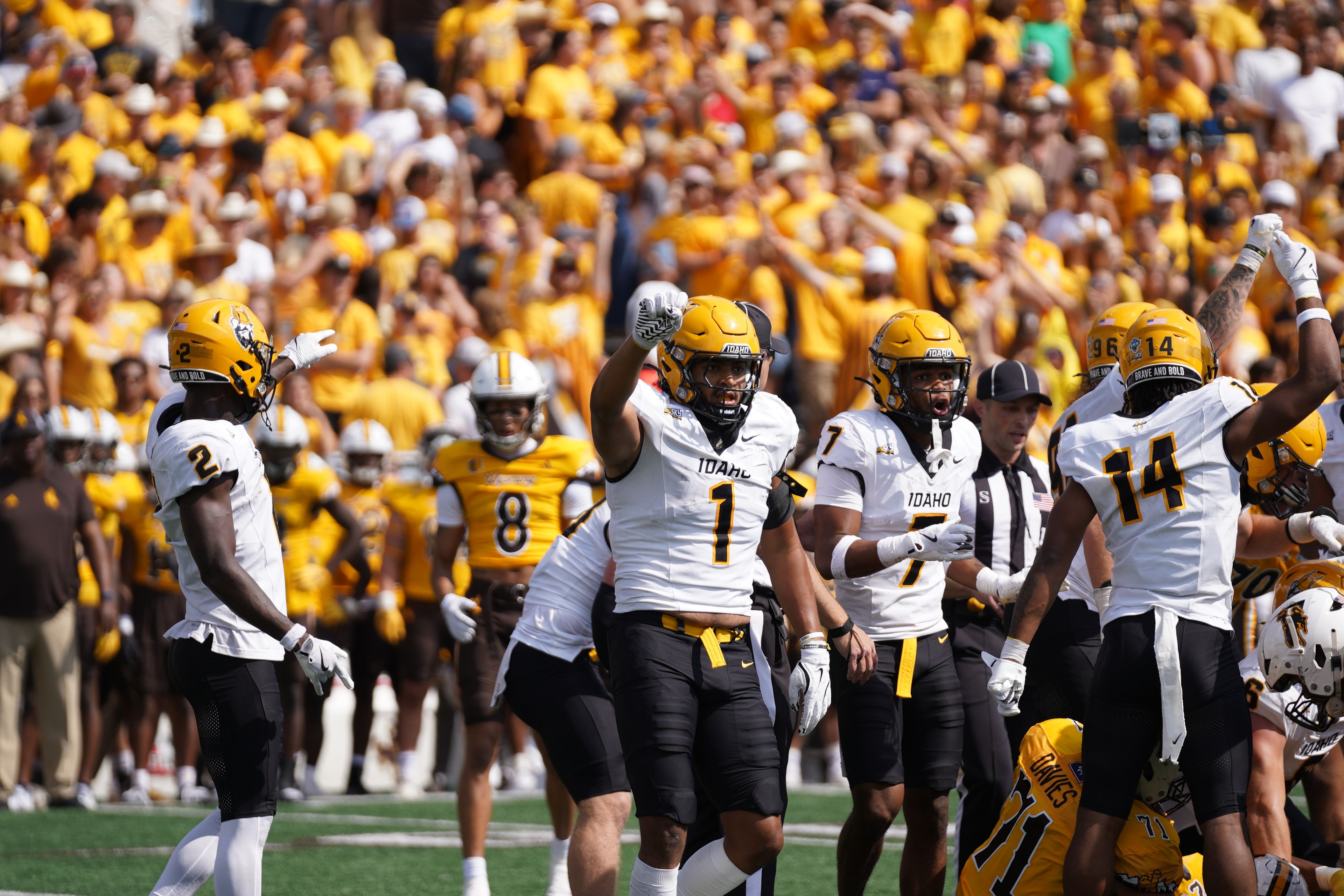 Idaho defensive end Keyshawn James-Newby (1) and his teammates hold up their fists to celebrate a defensive play in a game against Wyoming on Saturday, Sept. 7, in Laramie, Wyo.