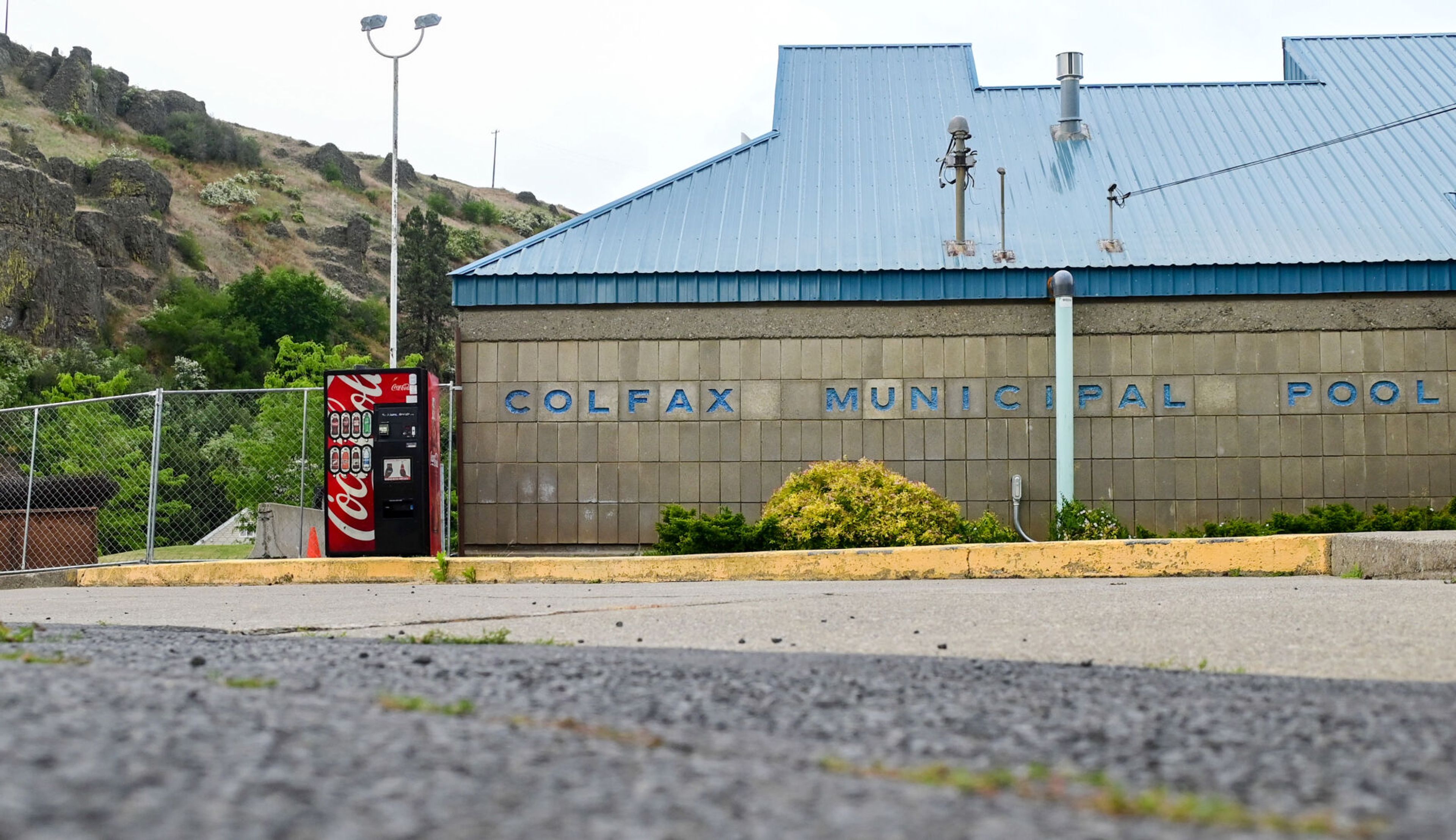 Construction fencing wraps around the sides of the Colfax Municipal Pool on Monday. The facility is closed for renovations this year.