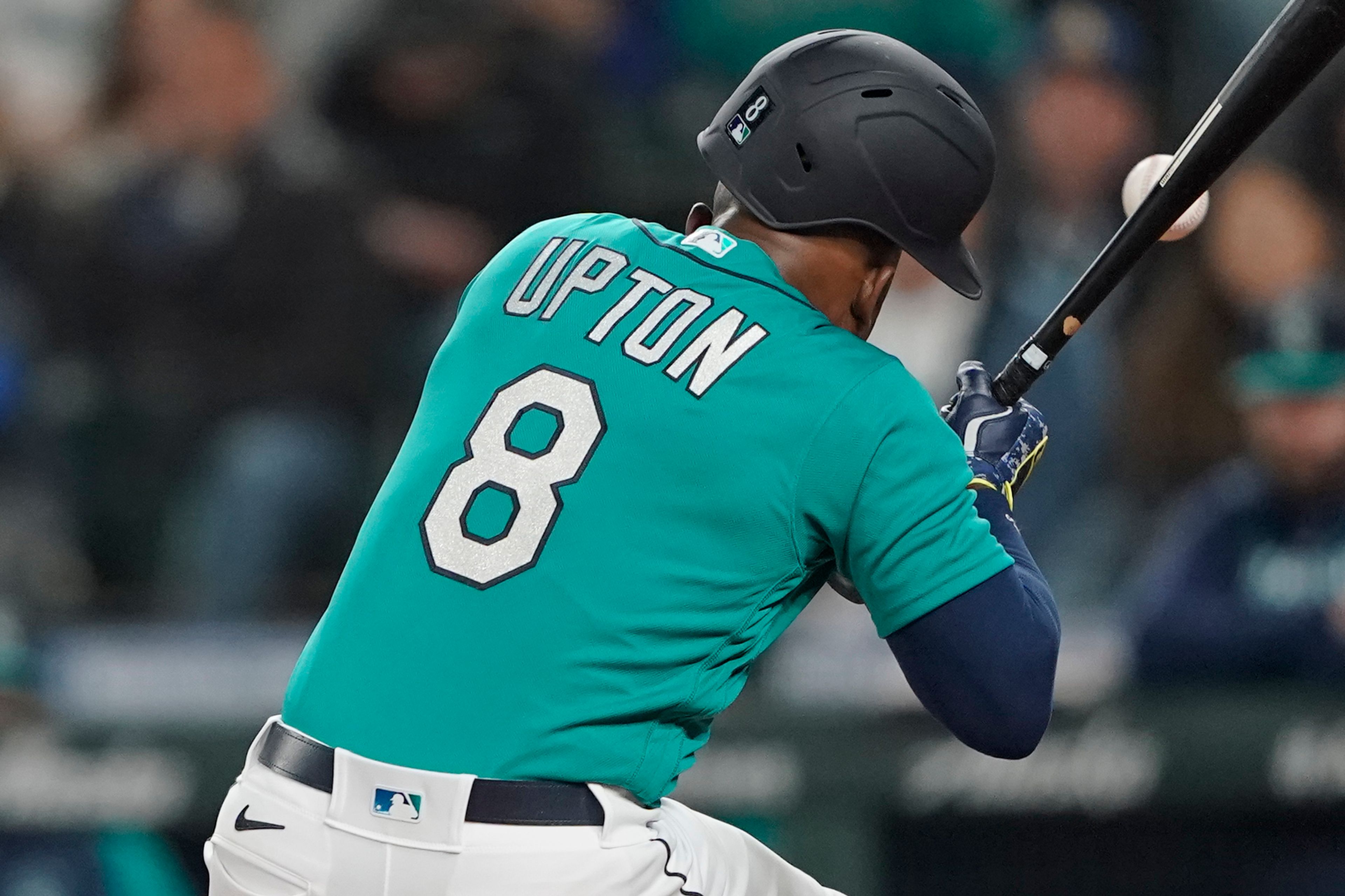 Seattle Mariners' Justin Upton is hit by a pitch during the fifth inning of a baseball game against the Los Angeles Angels, Friday, June 17, 2022, in Seattle. Upton left the game after the injury. (AP Photo/Ted S. Warren)