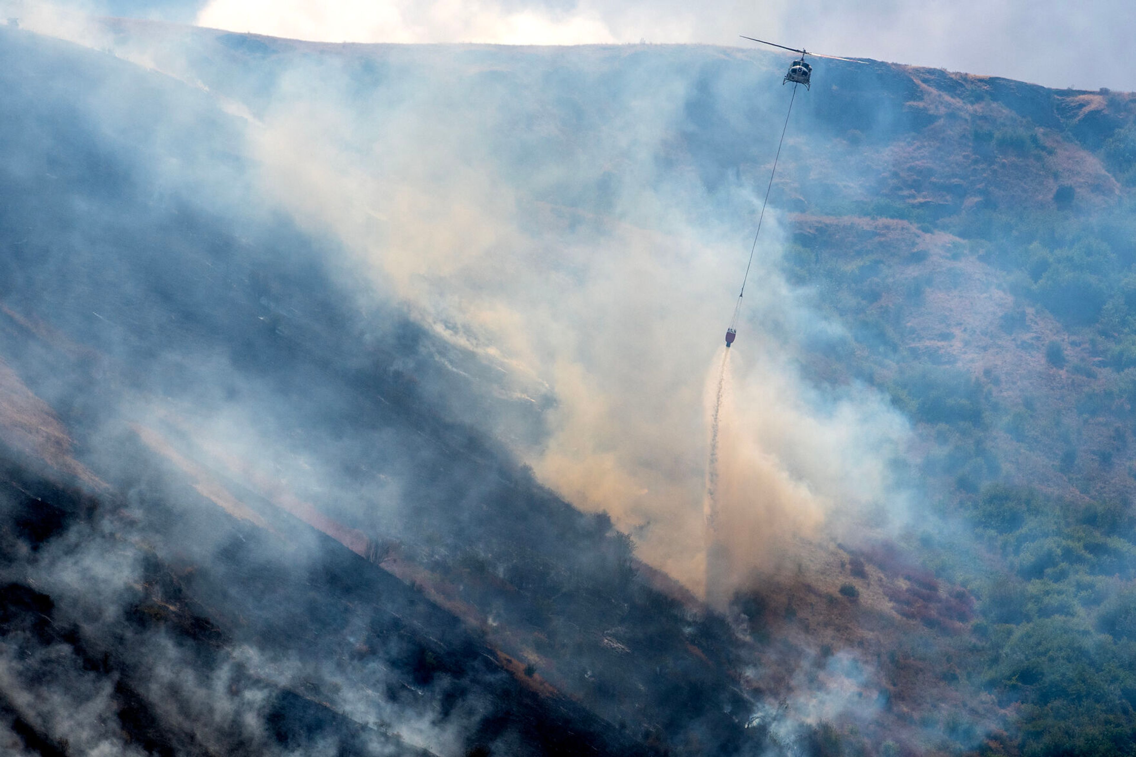 A helicopter makes a drop on the Lower Granite Fire Tuesday off the Snake River.