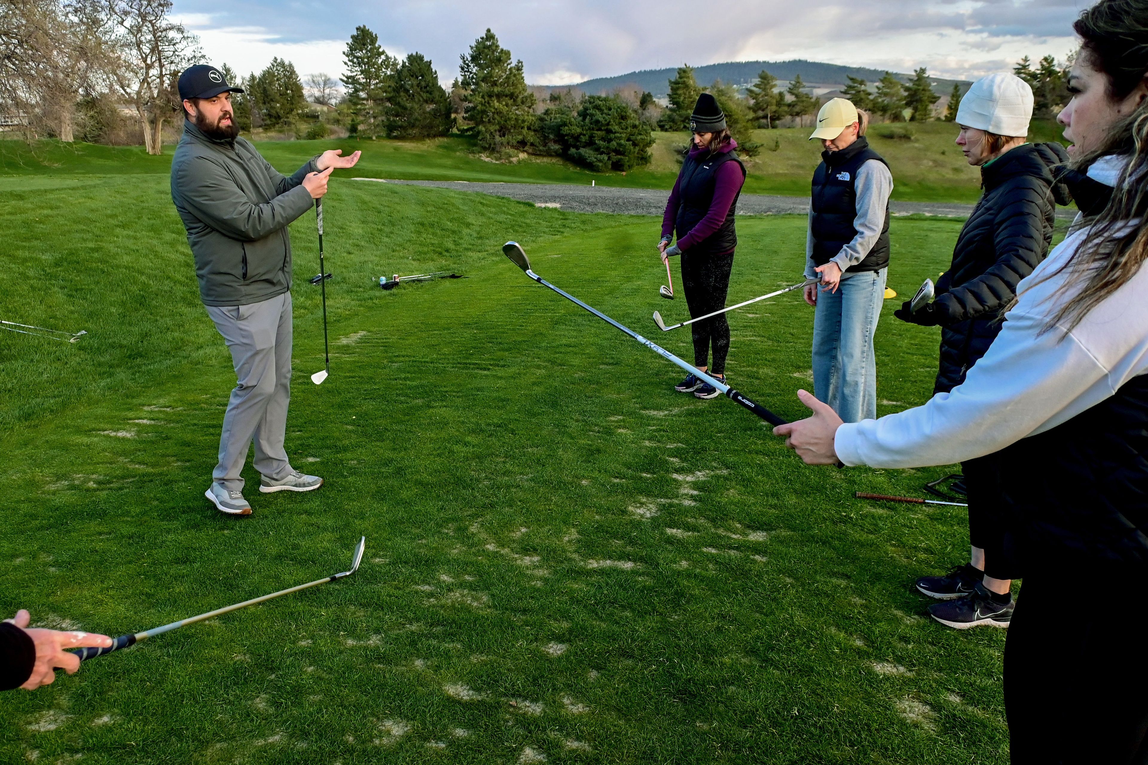 Michael Wagner, left, head golf professional at the University of Idaho Golf Course, demonstrates how to grip a golf club at a women’s class in Moscow on Tuesday.