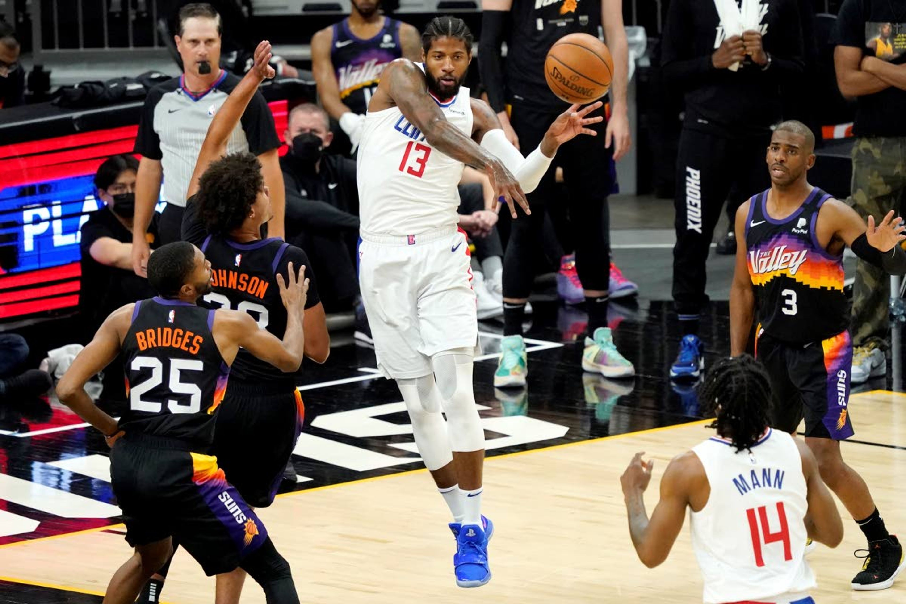 Associated PressClippers guard Paul George (13) passes as Suns forward Cameron Johnson (23) looks on during the first half of Game 5 of the NBA Western Conference finals on Monday in Phoenix.