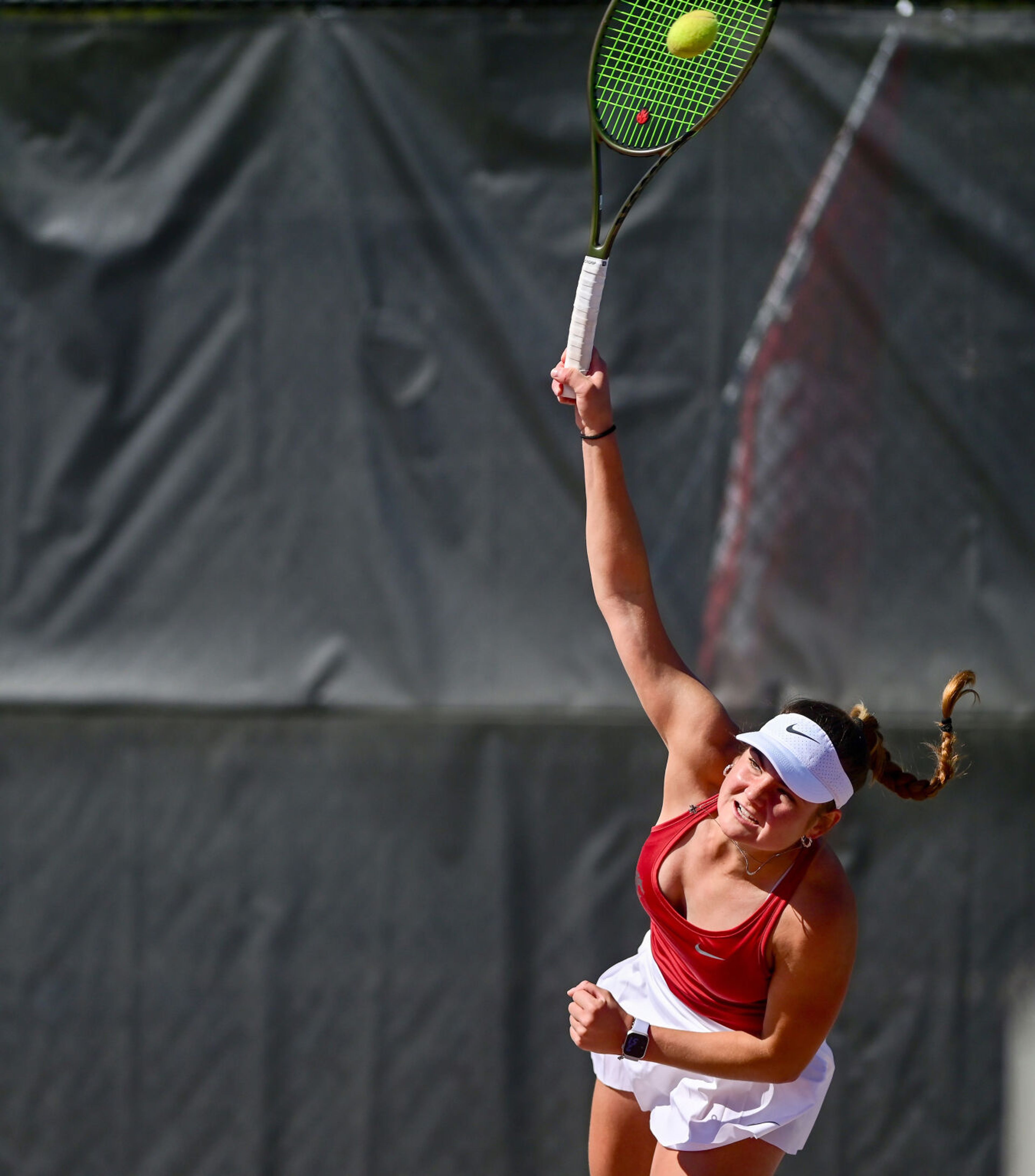 Washington State’s Martina Markov serves the ball in a singles match against Washington’s Dariya Detkovskaya in Pullman on Friday.