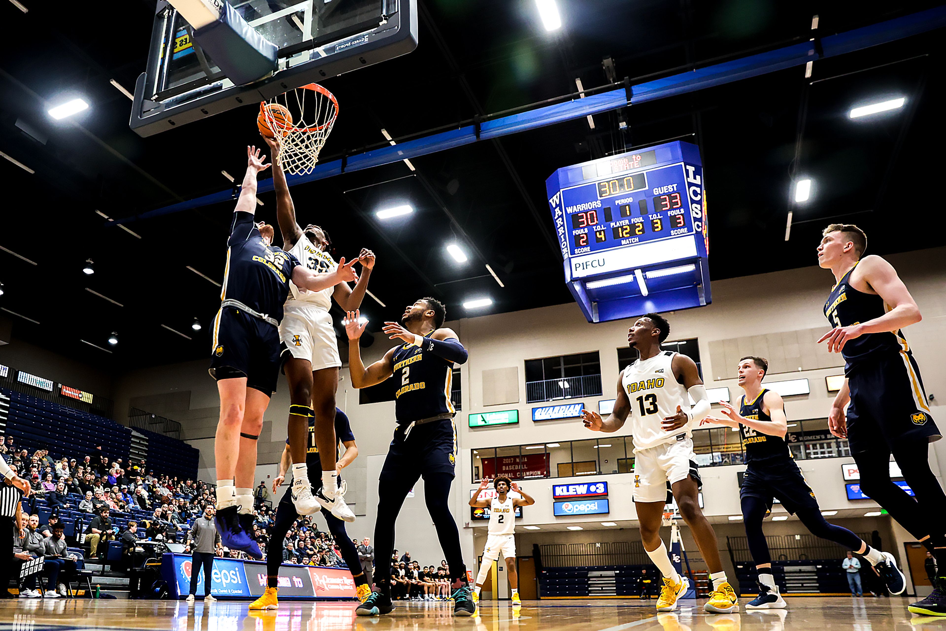 Idaho forward Nigel Burris shoots a layup as Northern Colorado center Theo Hughes guards him in a Big Sky game at the P1FCU Activity Center on the Lewis-Clark State College campus Thursday in Lewiston.