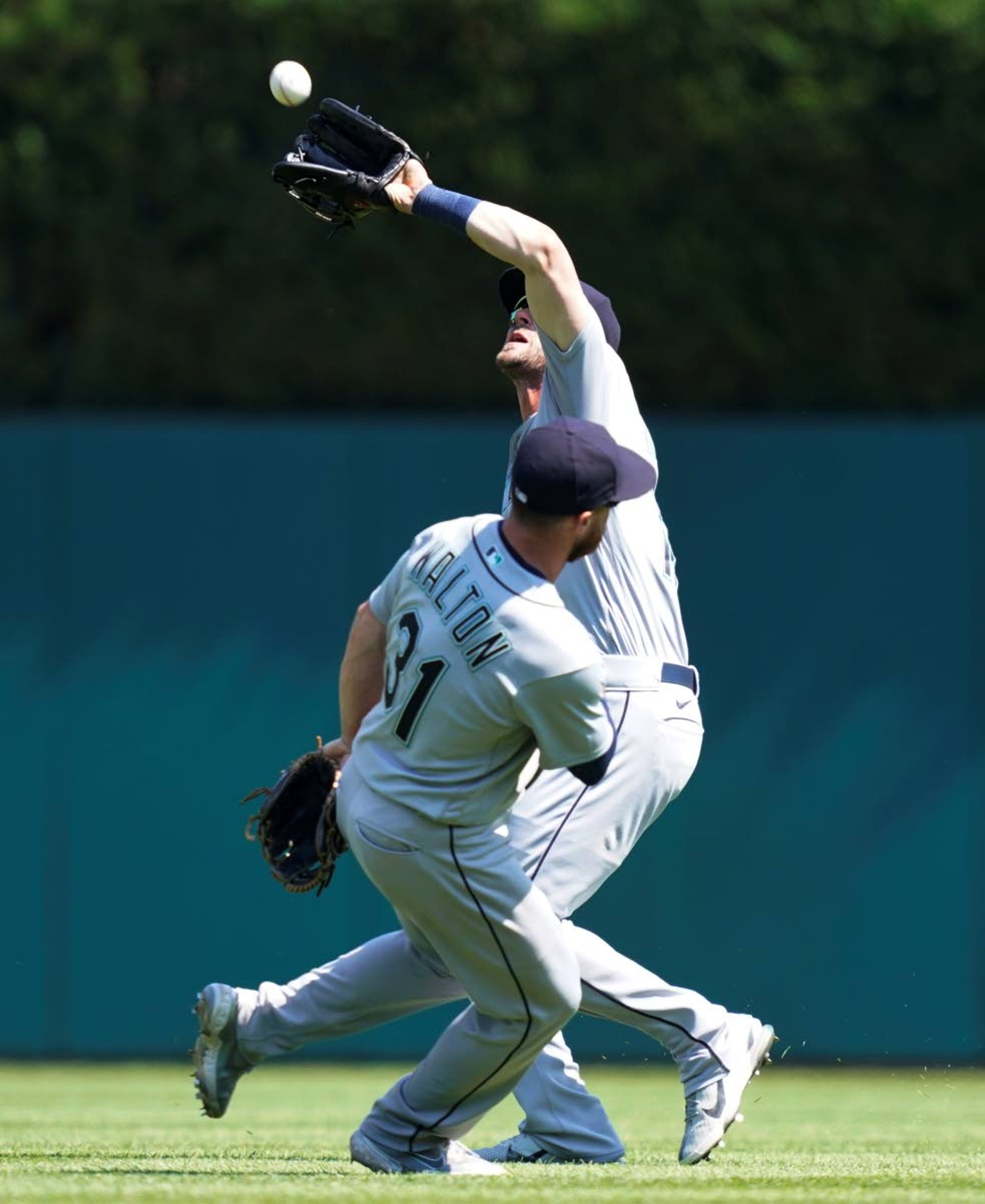 Seattle Mariners second baseman Donovan Walton (31) allows right fielder Mitch Haniger to catch the fly out hit by Detroit Tigers' Willi Castro during the seventh inning of a baseball game, Thursday, June 10, 2021, in Detroit. (AP Photo/Carlos Osorio)