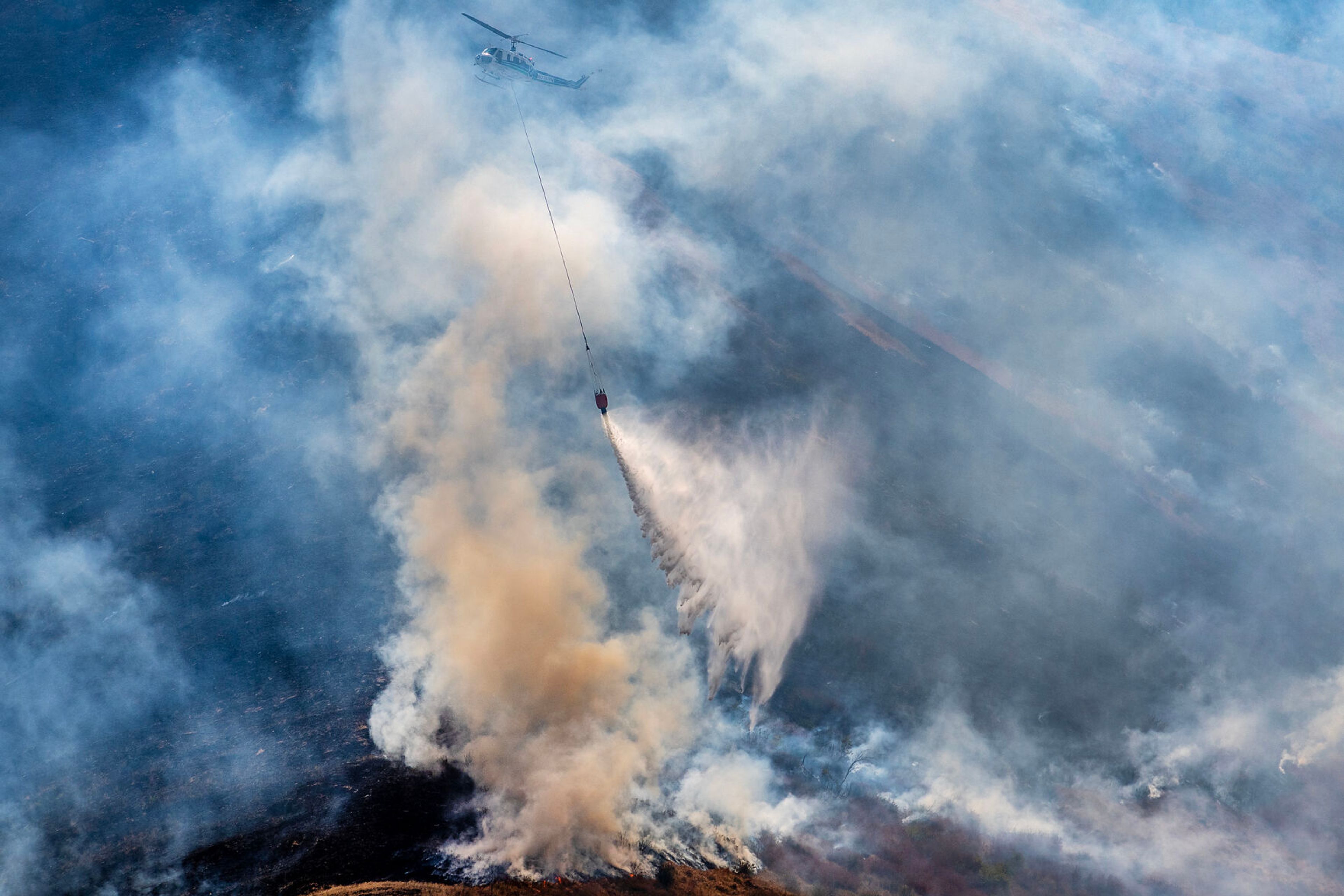 A helicopter makes a drop on the Lower Granite Fire Tuesday off the Snake River.