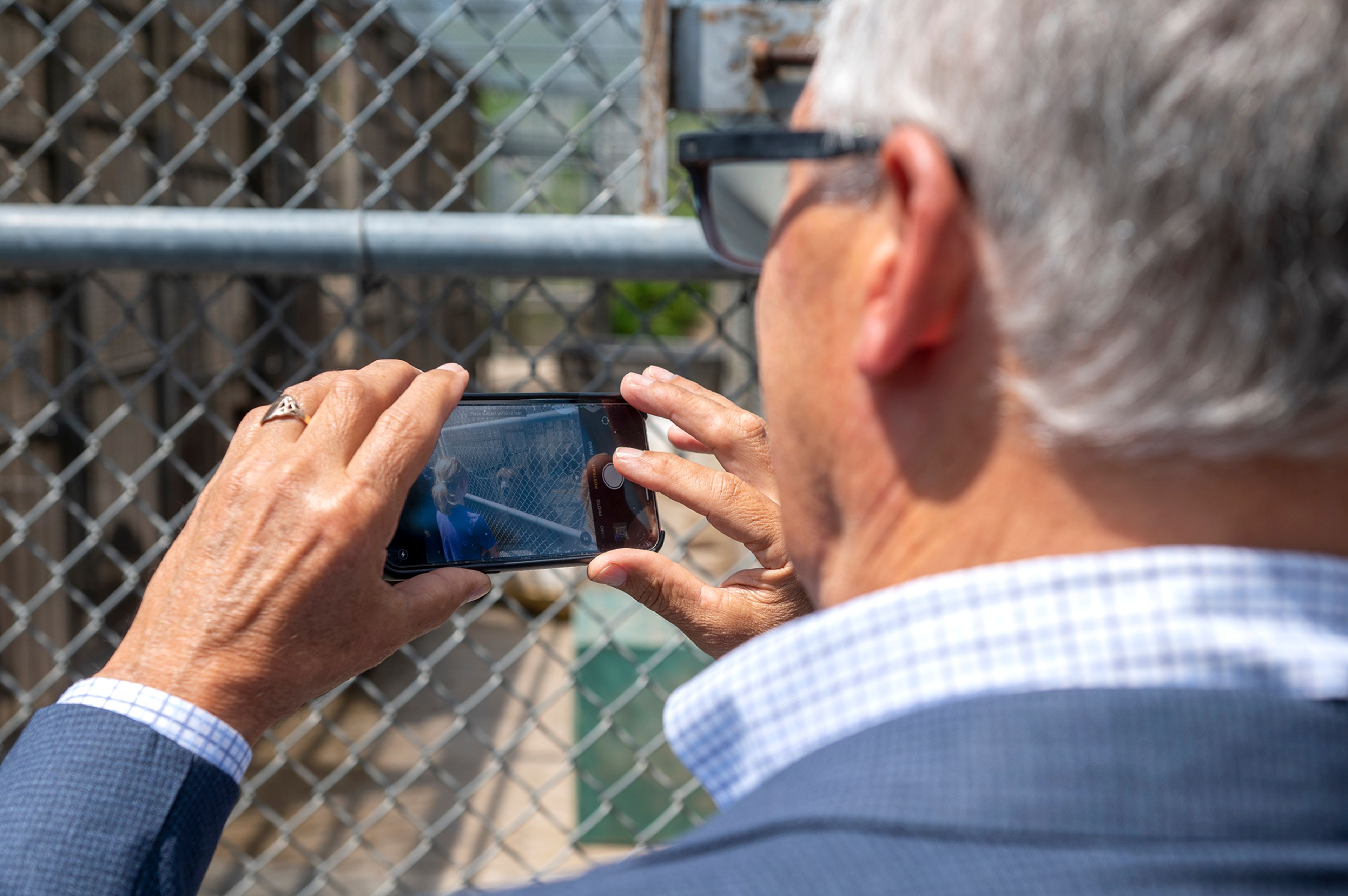 Washington Gov. Jay Inslee takes a photo of his granddaughter as she makes eye contact with a grizzly bear at Washington State University’s Bear Center on Thursday afternoon in Pullman.