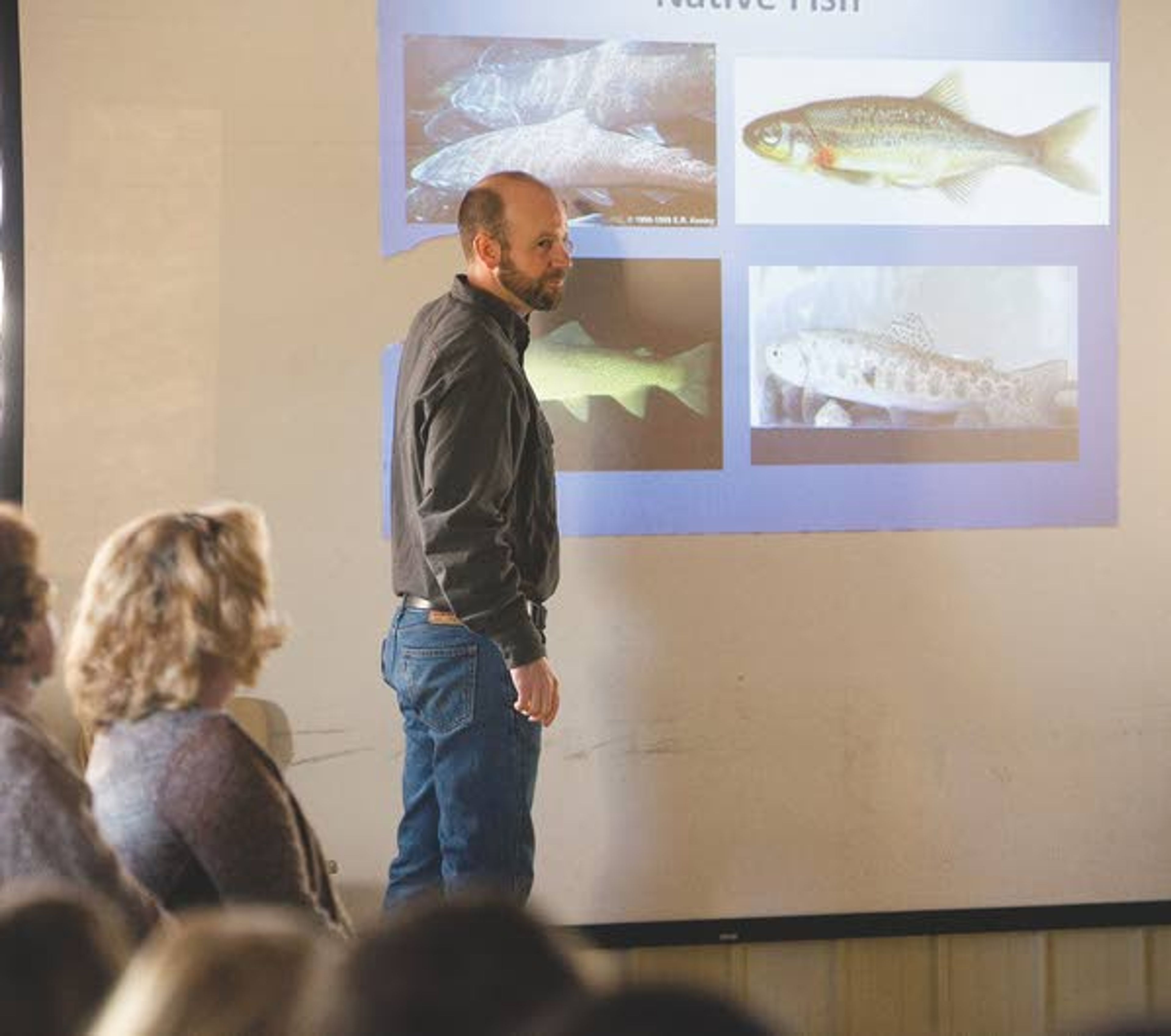 Brett Bowersox, center, a fish biologist with Idaho Department of Fish and Game, shows a slide depicting many Idaho native fish as part of a steelhead egg hatching project at Moscow Charter School on Monday. IDFG delivered one hundred steelhead eggs to MCS on Wednesday.